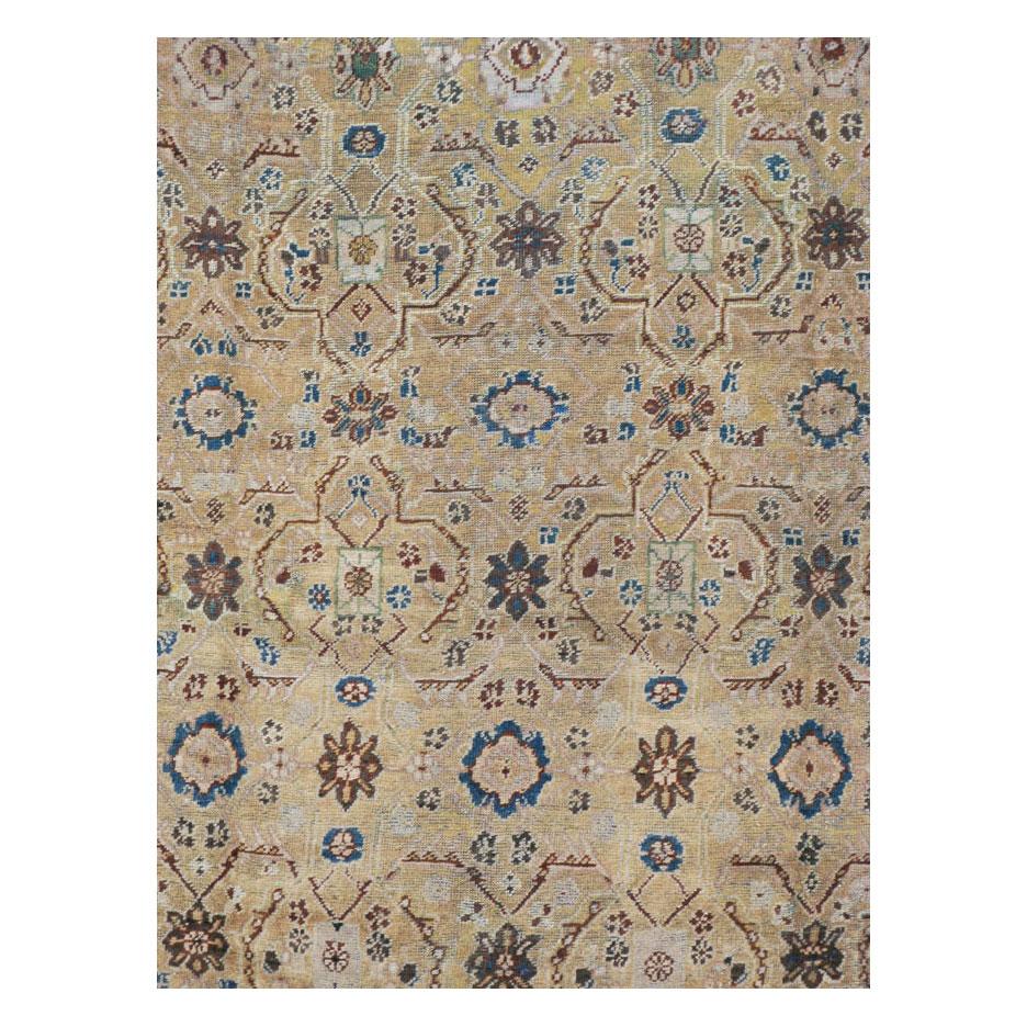 An antique Persian Mahal room size carpet handmade during the early 20th century. The design along with the tan field and brick red border give the rug an overall rustic appeal.

Measures: 8' 11
