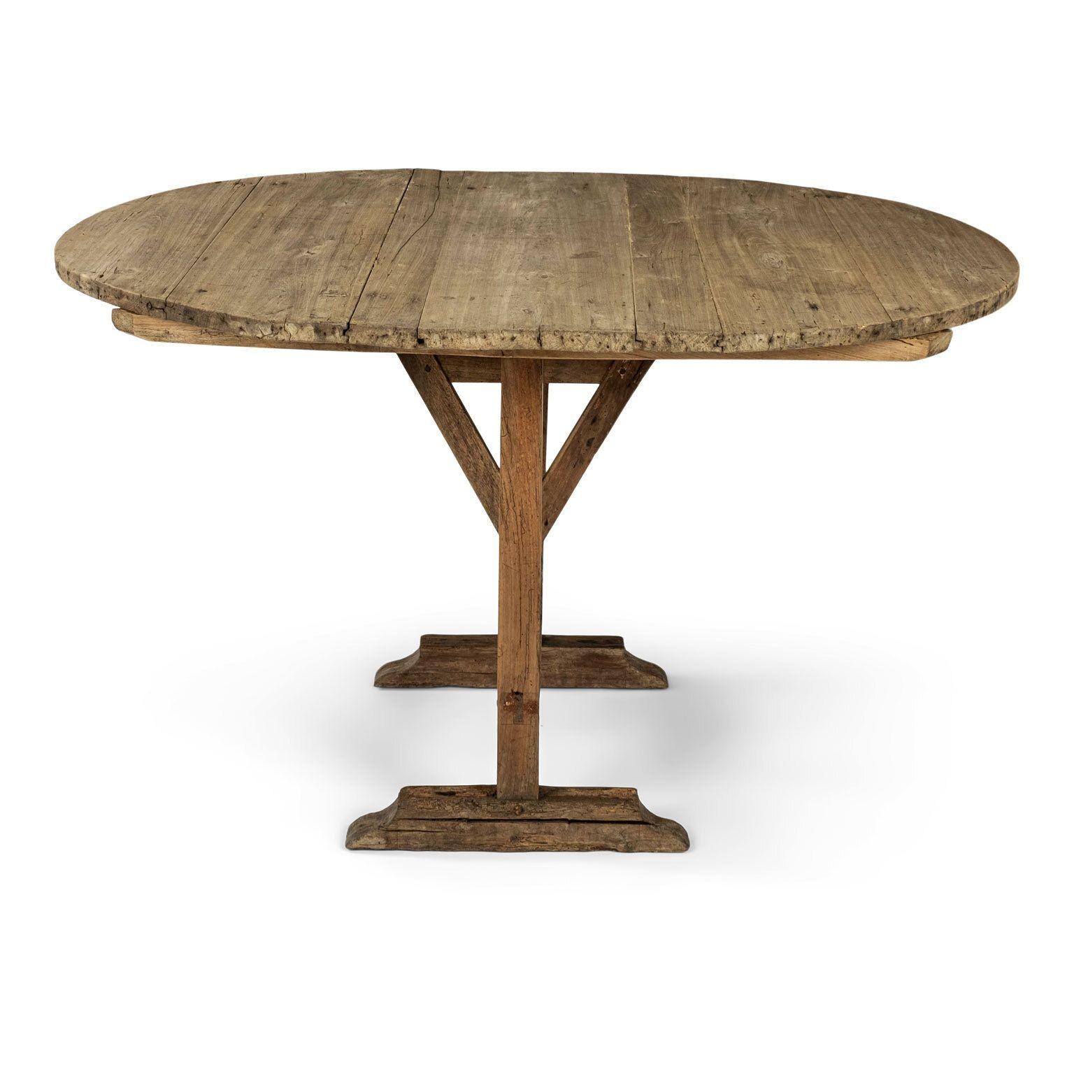 Rustic early sun-bleached oval-shape tilt-top table (circa 1830-1850). Simple, elegant design with functional tilt-top. Oval bleached walnut top raised upon bleached oak swivel-harp base. Jointed newly tightened. Sturdy, stable. Evidence of past