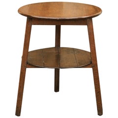 Rustic English 1860s Oak Cricket Table with Splayed Legs, Circular Top and Shelf