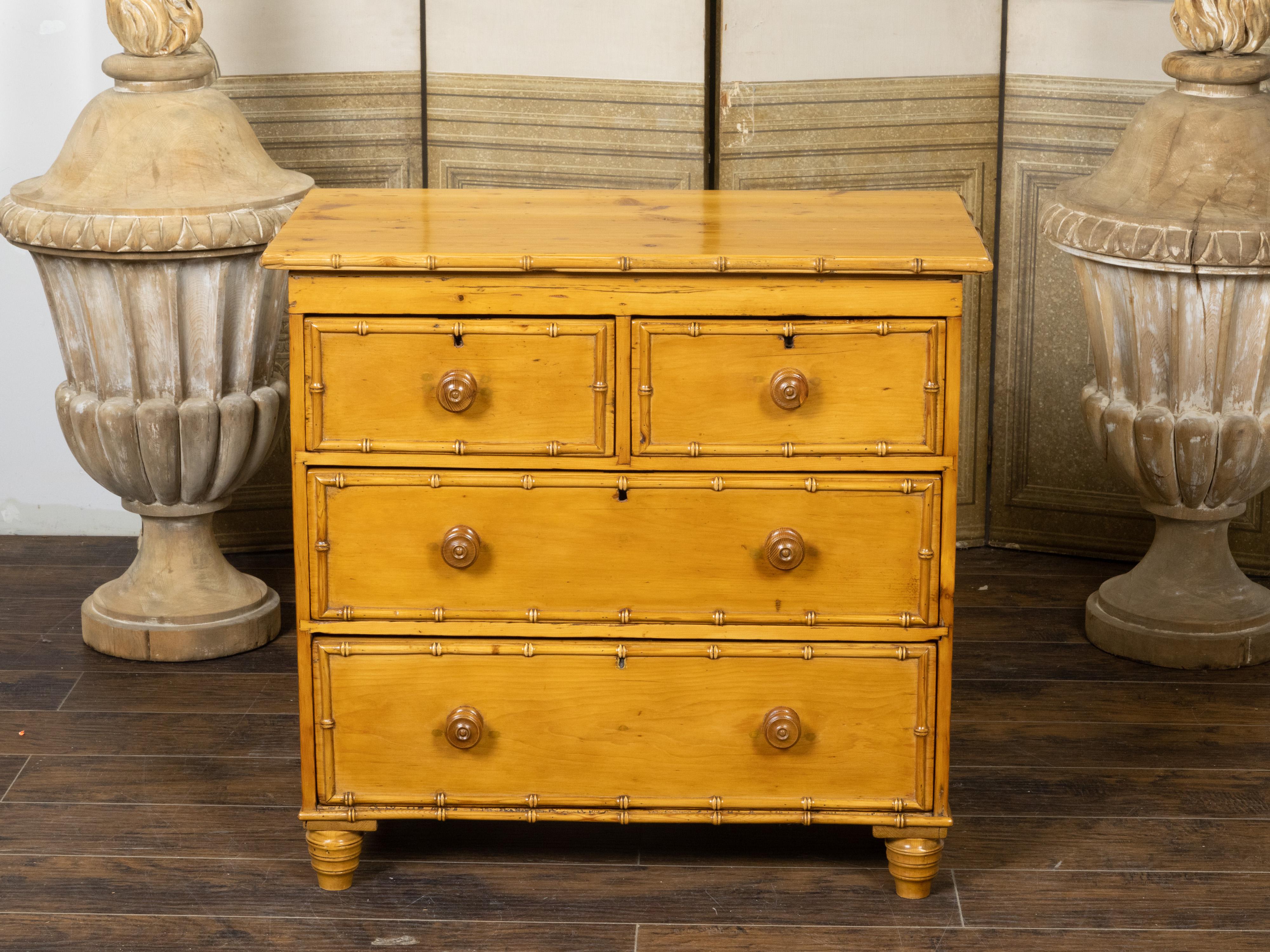 A rustic English pine chest from the 19th century, with faux bamboo accents, four drawers, turned feet and great character. Created in England during the 19th century, this pine chest features a rectangular top sitting above a perfectly organized