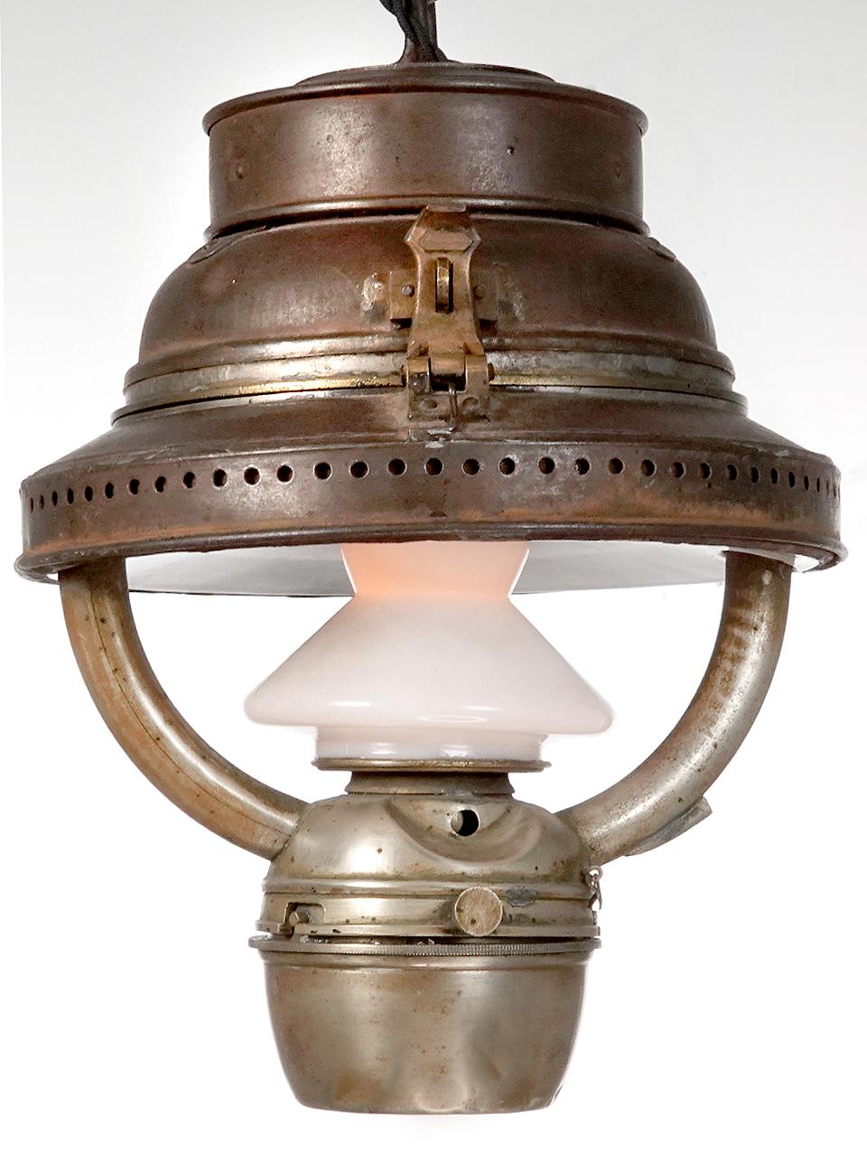 This is an interesting and well industrial made lantern.  Its not signed but has a small plaque that reads MADE IN ENGLAND. Construction is steel, brass and white baked on enamel. I am told that this type of lantern was used in an early railroad