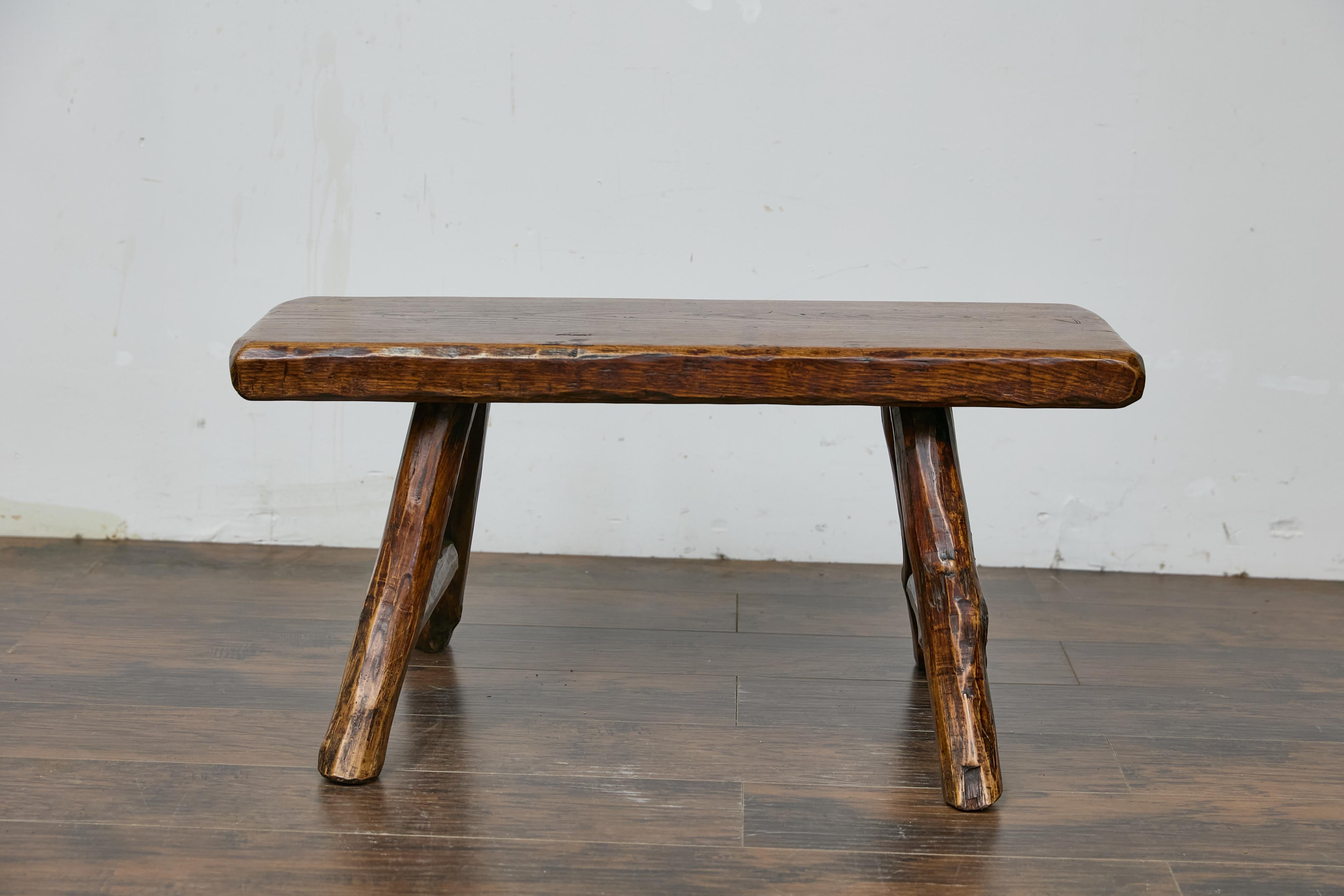 An English rustic oak Craftsman's stool from the early 20th century with A-frame base. This English rustic oak Craftsman's stool from the early 20th century captures the eye with its charming simplicity and organic feel. The small rectangular top,