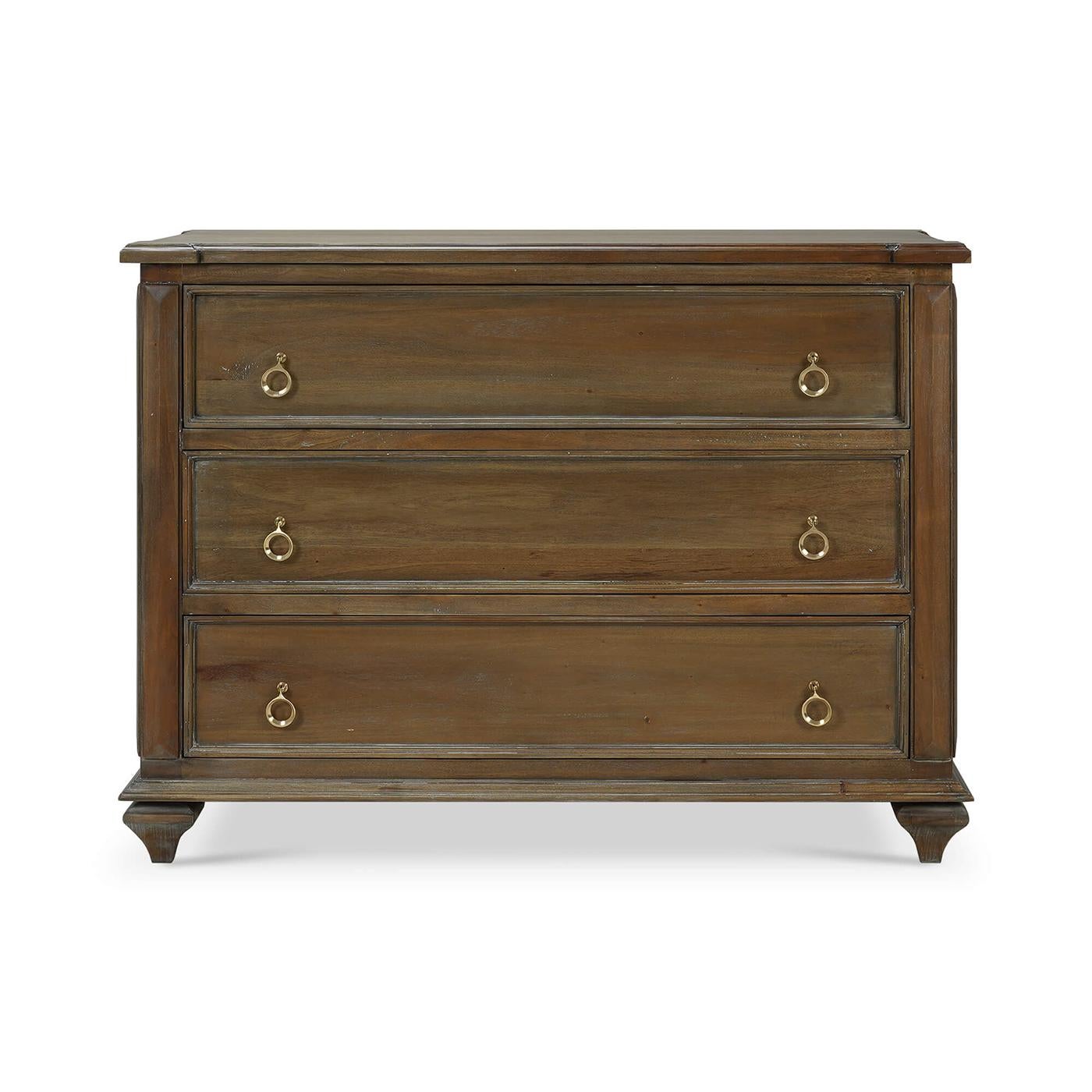 Crafted from solid mahogany, in our warm straw wash finish that highlights the natural beauty of the wood grain.

With three spacious drawers, each adorned with gold ring pulls, providing ample storage for your clothing, accessories, or household