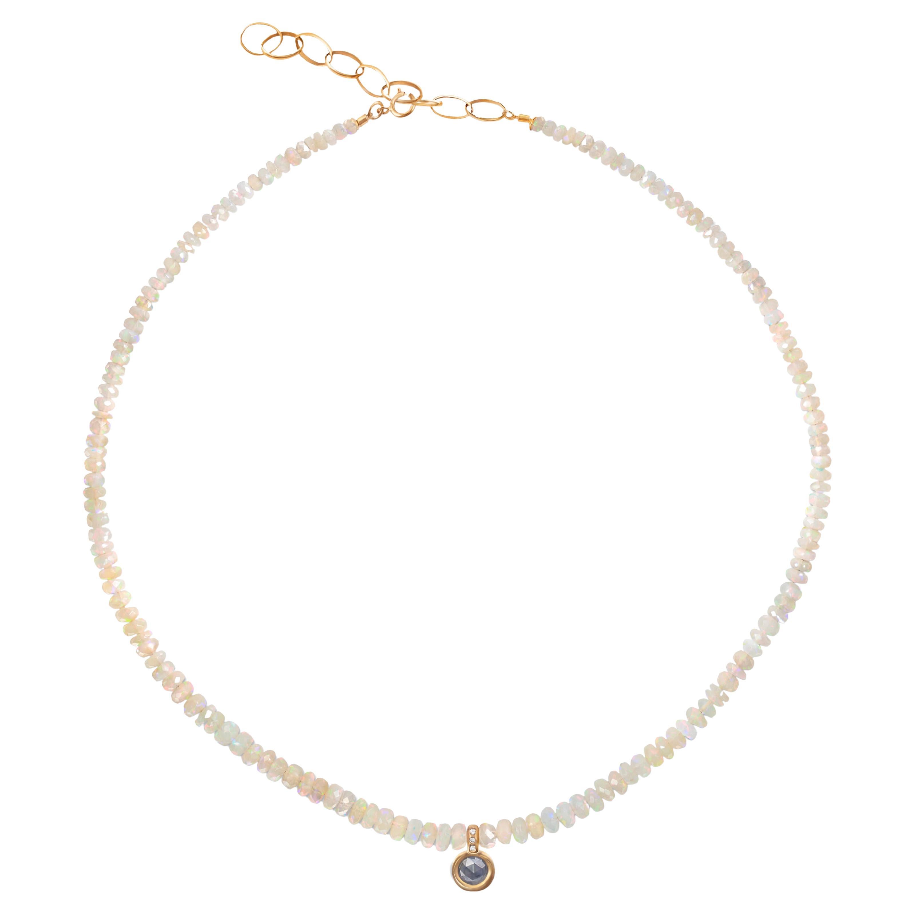 This handmade necklace is strung with graduated rustic-cut faceted Ethiopian opals finished with a central 18k gold and diamond pendant.  Cast in 18-karat gold, the pendant features a checkerboard-cut opaque grey rosecut diamond and three white