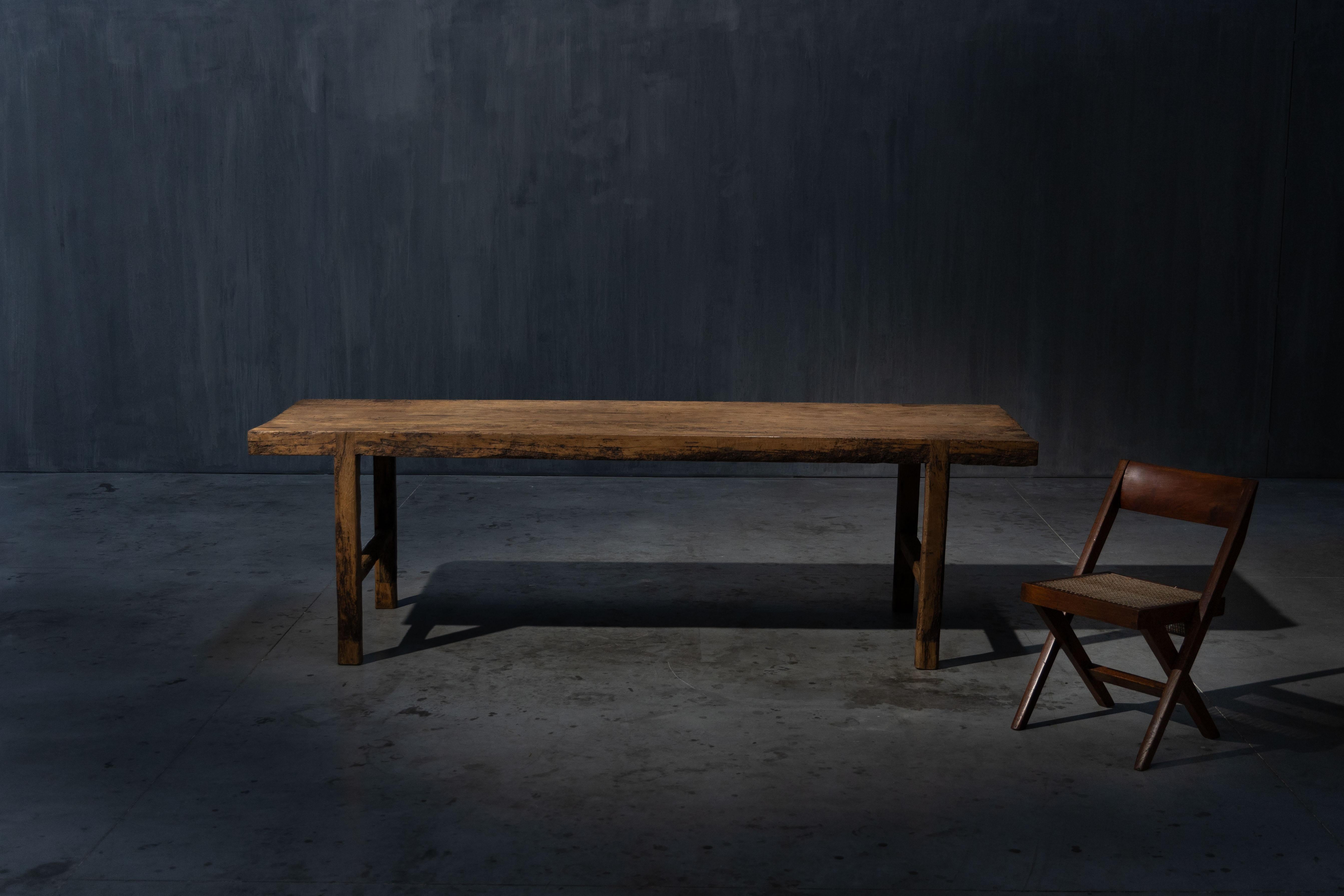 Cette grande table de ferme française datant d'environ 1950 est fabriquée en bois massif et met en valeur le charme intemporel du design rustique français. Ses proportions généreuses permettent d'accueillir confortablement 8 à 10 personnes, ce qui