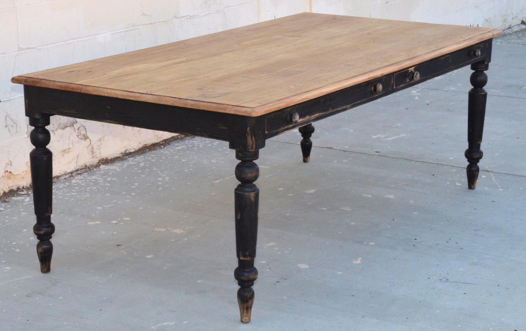 This farmhouse table is made from reclaimed pine with a painted base, turned legs and two large drawers which can be pulled out from either side. Seen here in 110