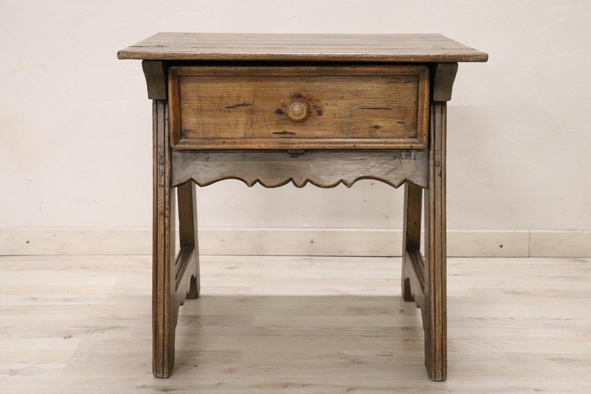 Curious side table in solid oak and fir wood. Equipped with a practical drawer on the front. A rustic side table perfect for a mountain or countryside setting. Due to its small size it can be used in different rooms of the house, in the bedroom as a