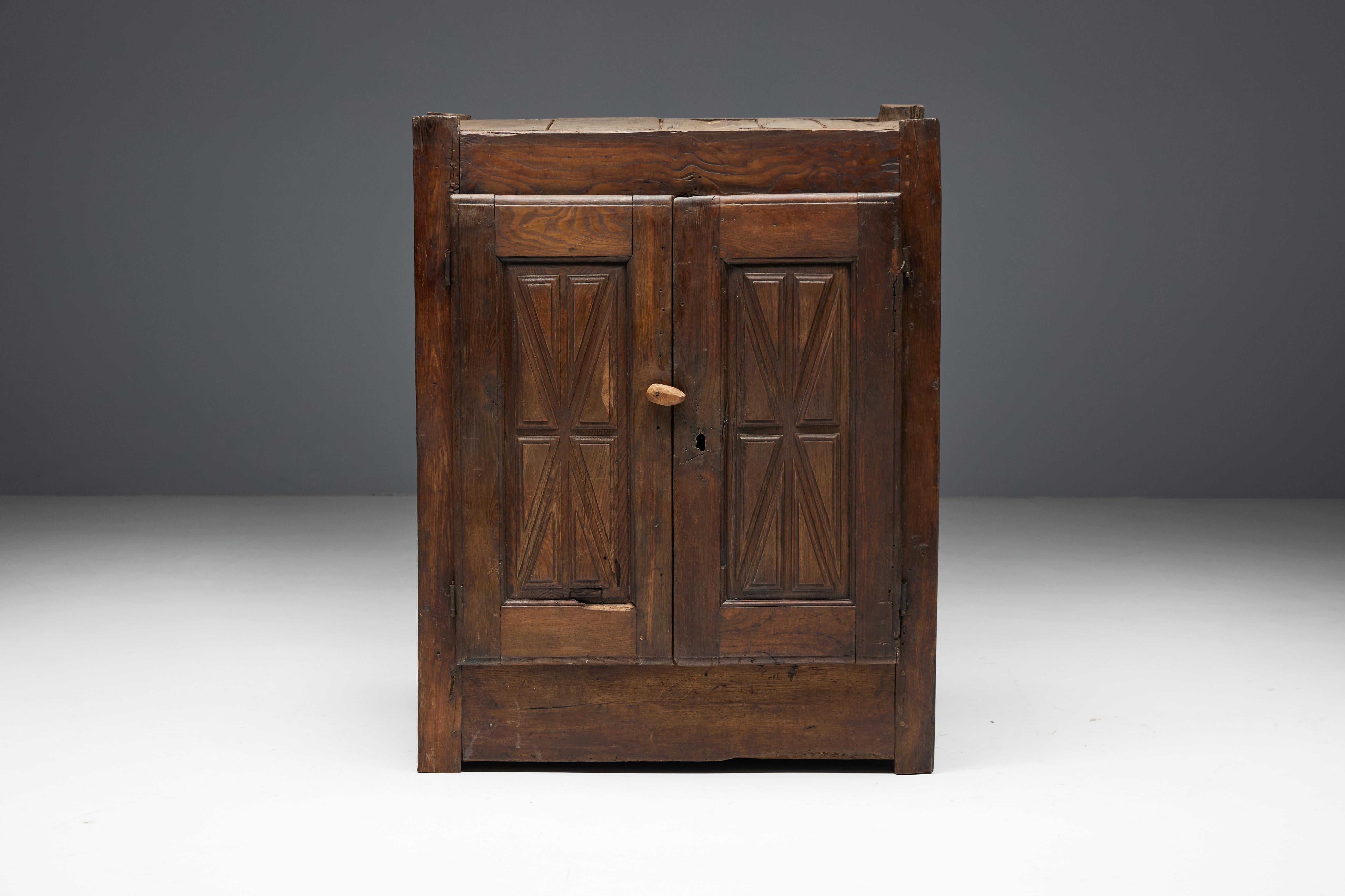 Art populaire chestnut cupboard from the Ardèche region, dating back to the 19th century. This exquisite piece hails from the rustic traditions of the South of France and is crafted from solid chestnut wood. Exuding historical charm with its
