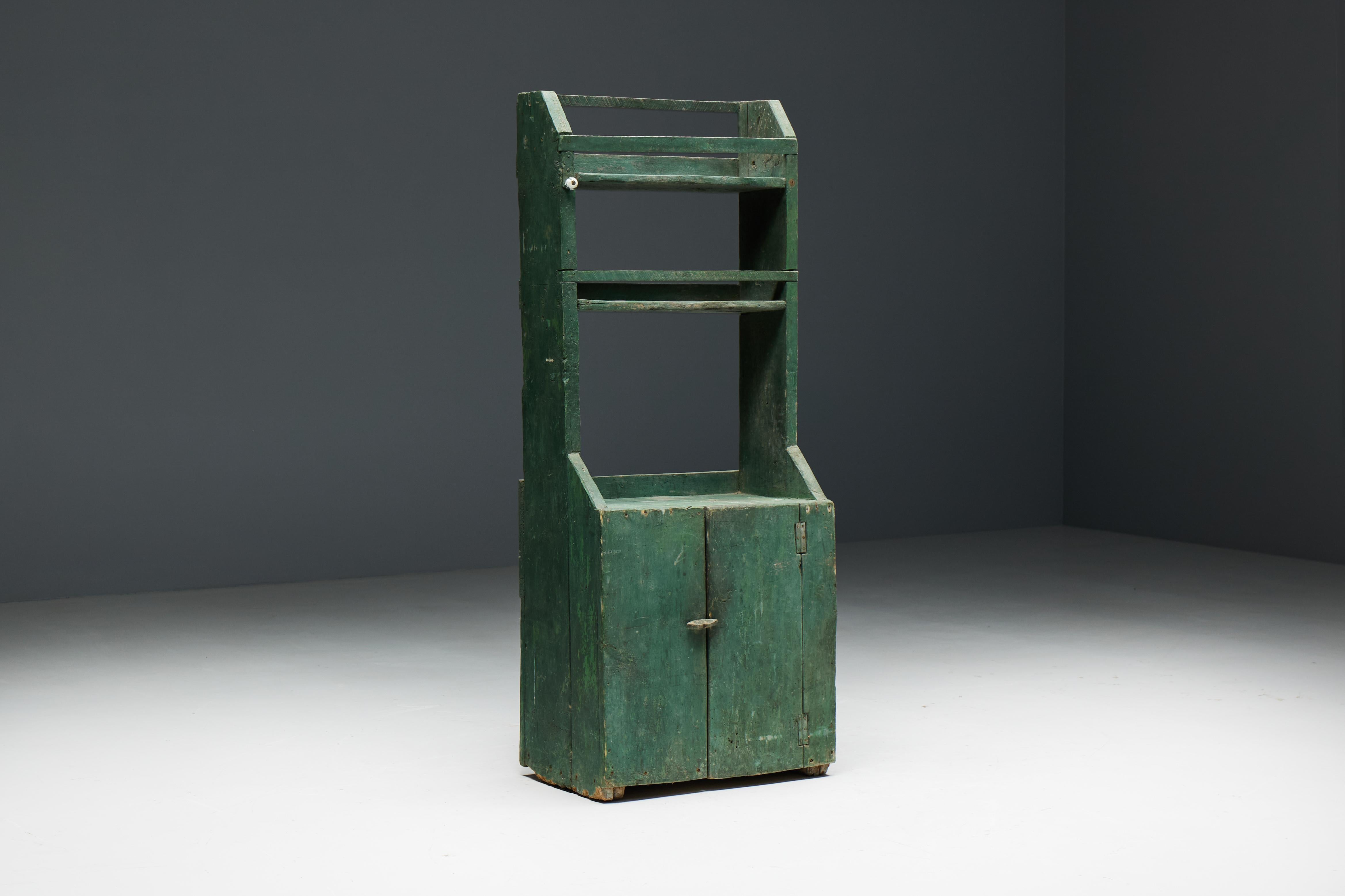 Folk art cupboard in a fascinating shade of green, made in 19th century France. With ample room to accommodate all your necessities, this cabinet is designed to be both practical and visually stunning. The top section of the cabinet remains open,