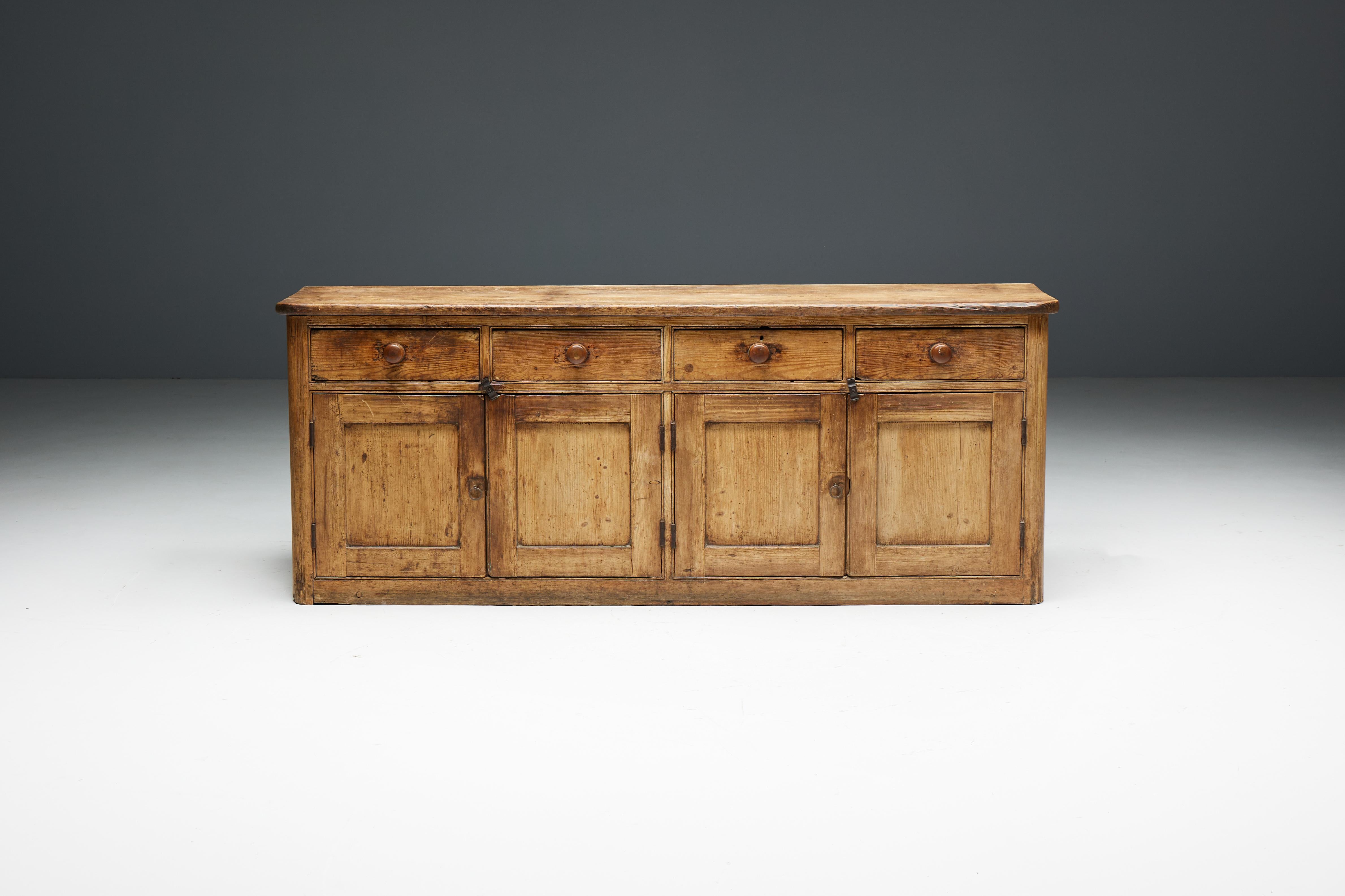 19th-century rustic softwood sideboard, a remarkable demonstration of masterful craftsmanship. Crafted from the finest softwood, this sideboard exemplifies unparalleled craftsmanship refined over generations. With four doors revealing generous