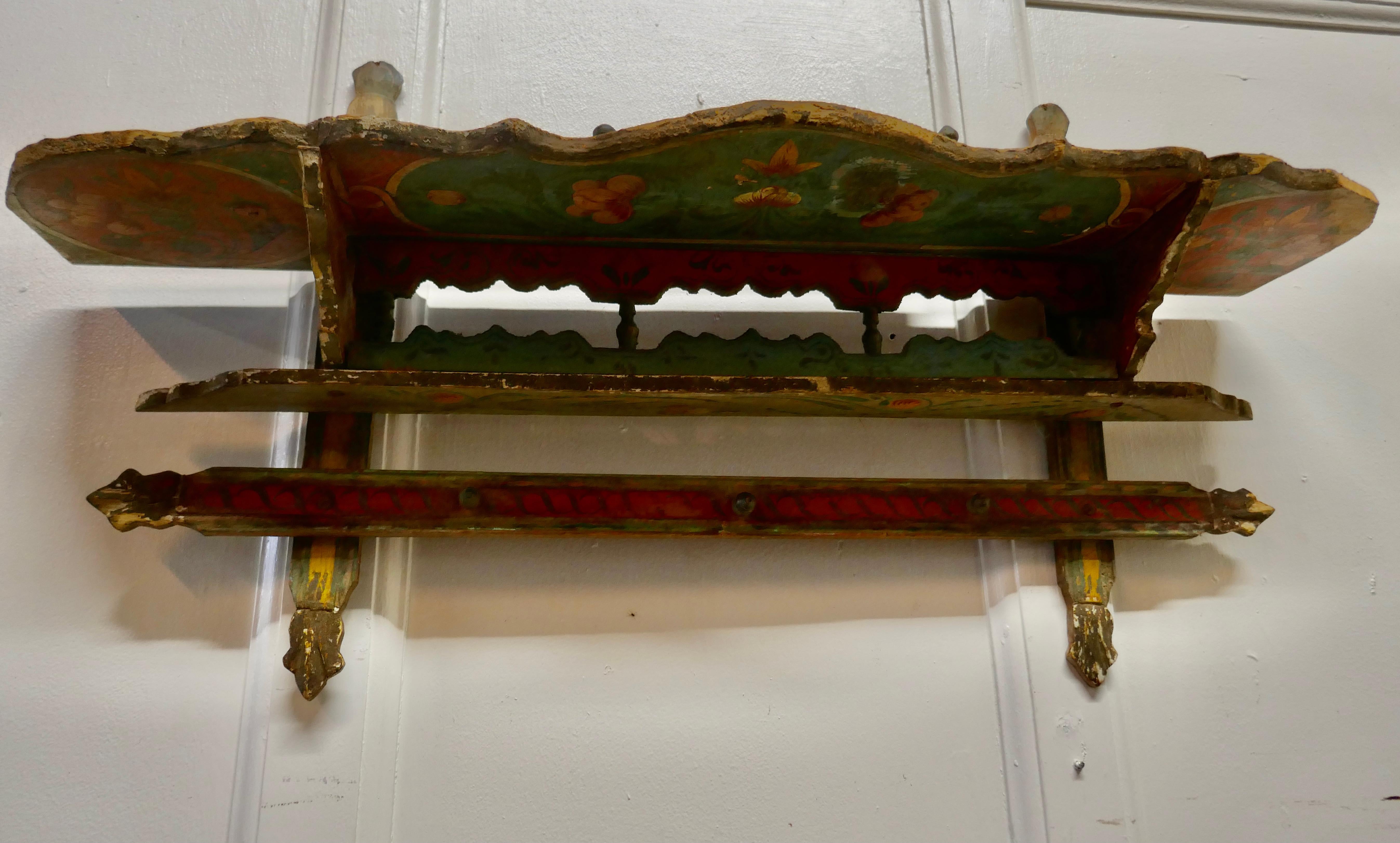 Rustic Folk Art wall shelf 

This charming little shelf comes from the South of France and it is painted in the Mediterranean Folk Style with many bright colours, sadly the paint is now worn and shabby, but still a very desirable piece

The