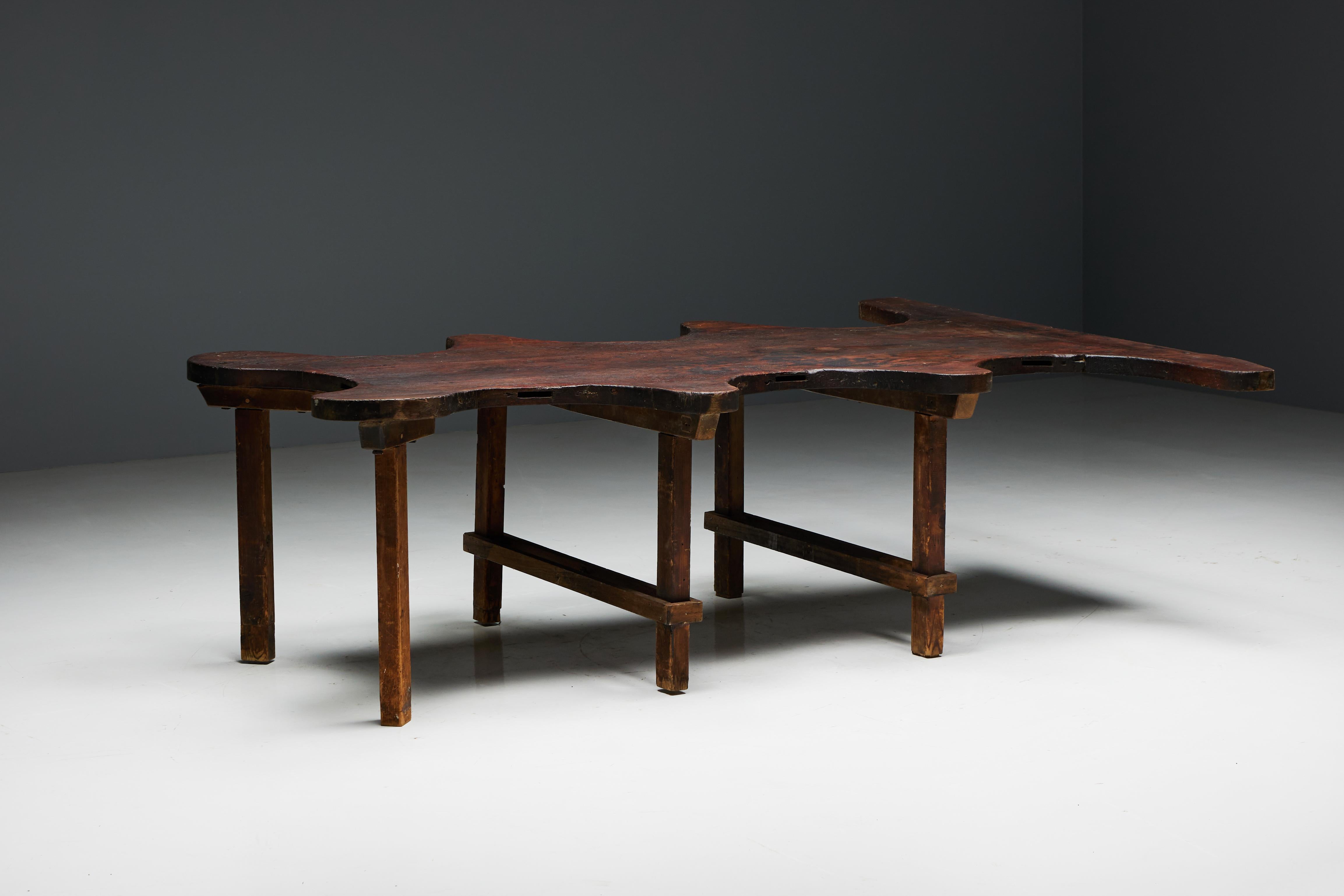Crafted with meticulous artistry, this free form table, repurposed from a goldsmith atelier, exudes organic charm and rustic elegance. Its sturdy oak wood bears the marks of time, a testament to its rich history. With ample space to accommodate up