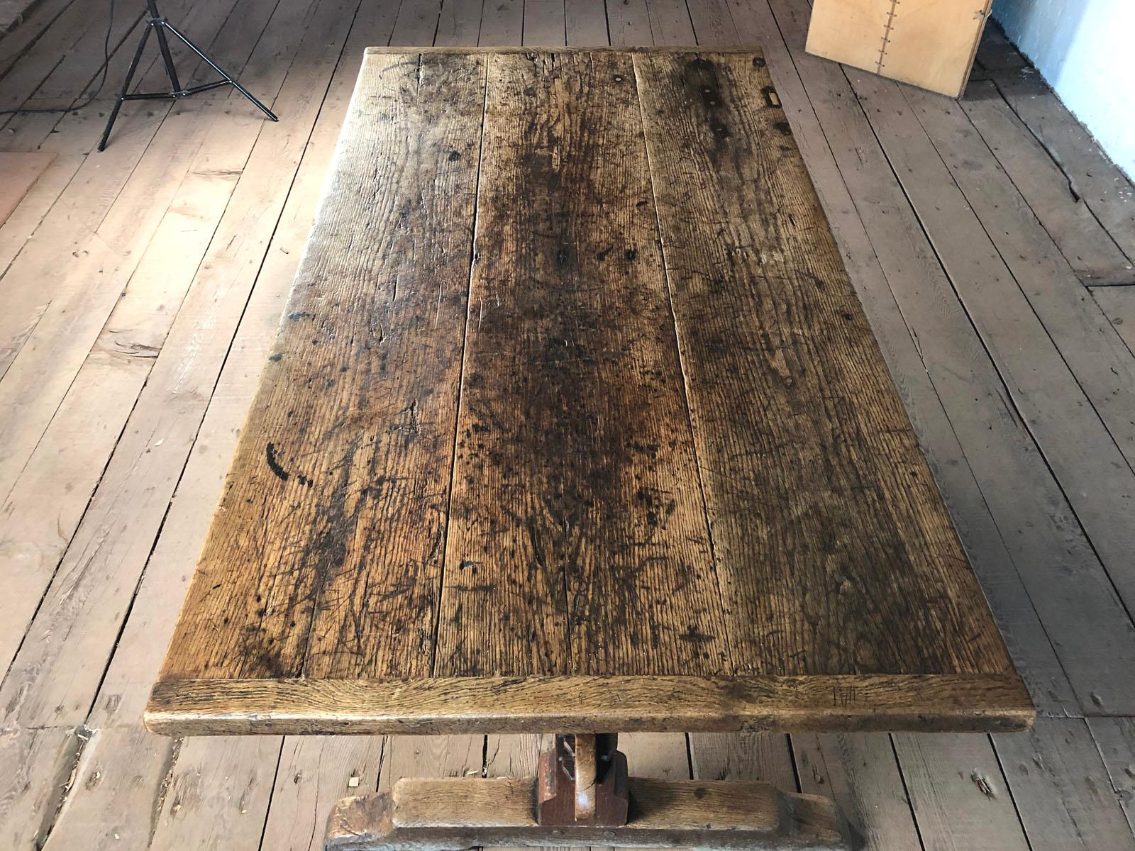 Rustic, very charming trestle table, the three plank chestnut top with narrow bread board ends supported by an oak trestle base, the uneven staining on the top created by use and age give it a unique personality.
The table is versatile, perfect for