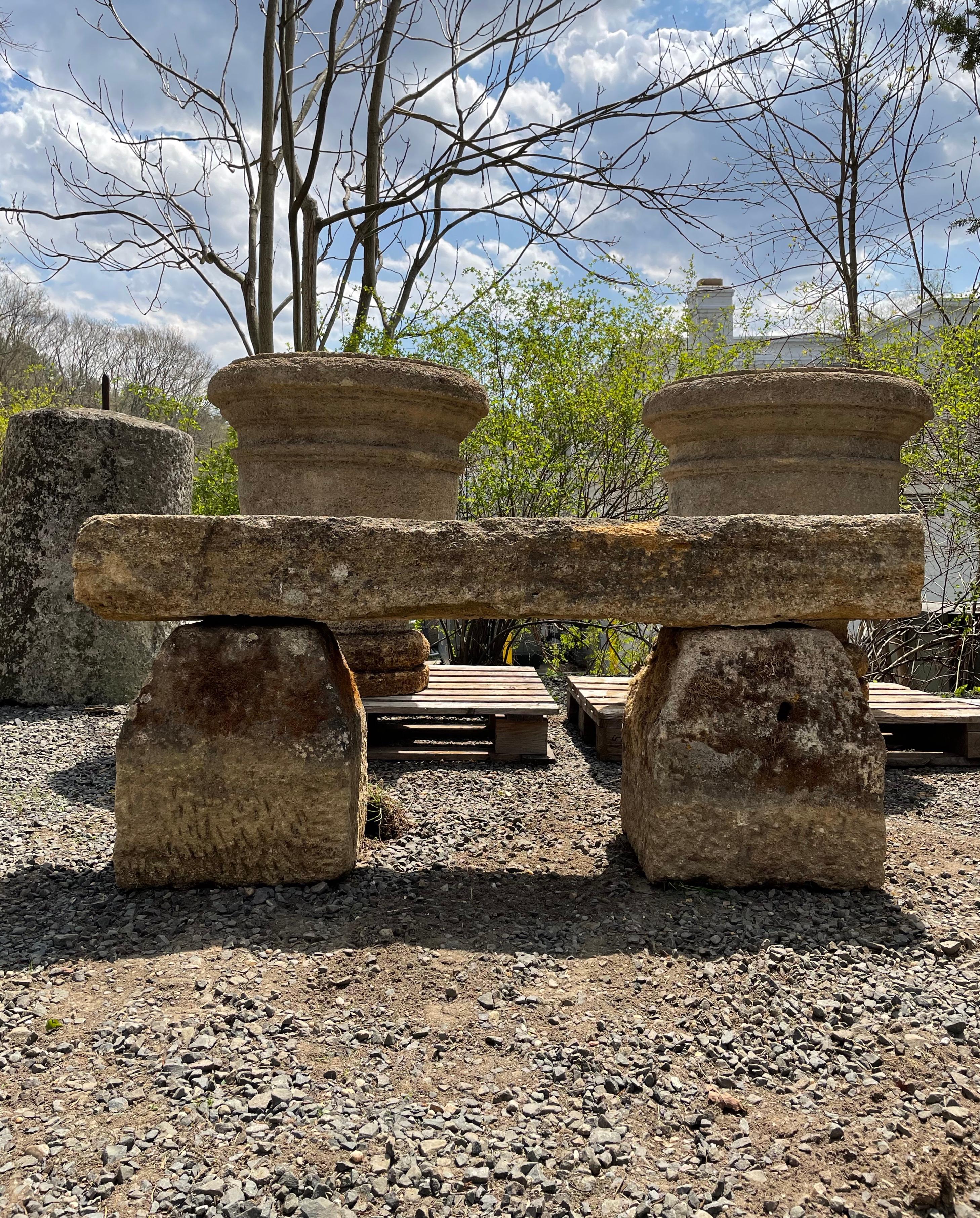 This is a wonderful stone bench, hand-carved from Baux stone, found in Provence, and dating to the late 18th C. The two supports are loaded with moss that will green up and flower again if the bench is placed in a moist and shady location, and the