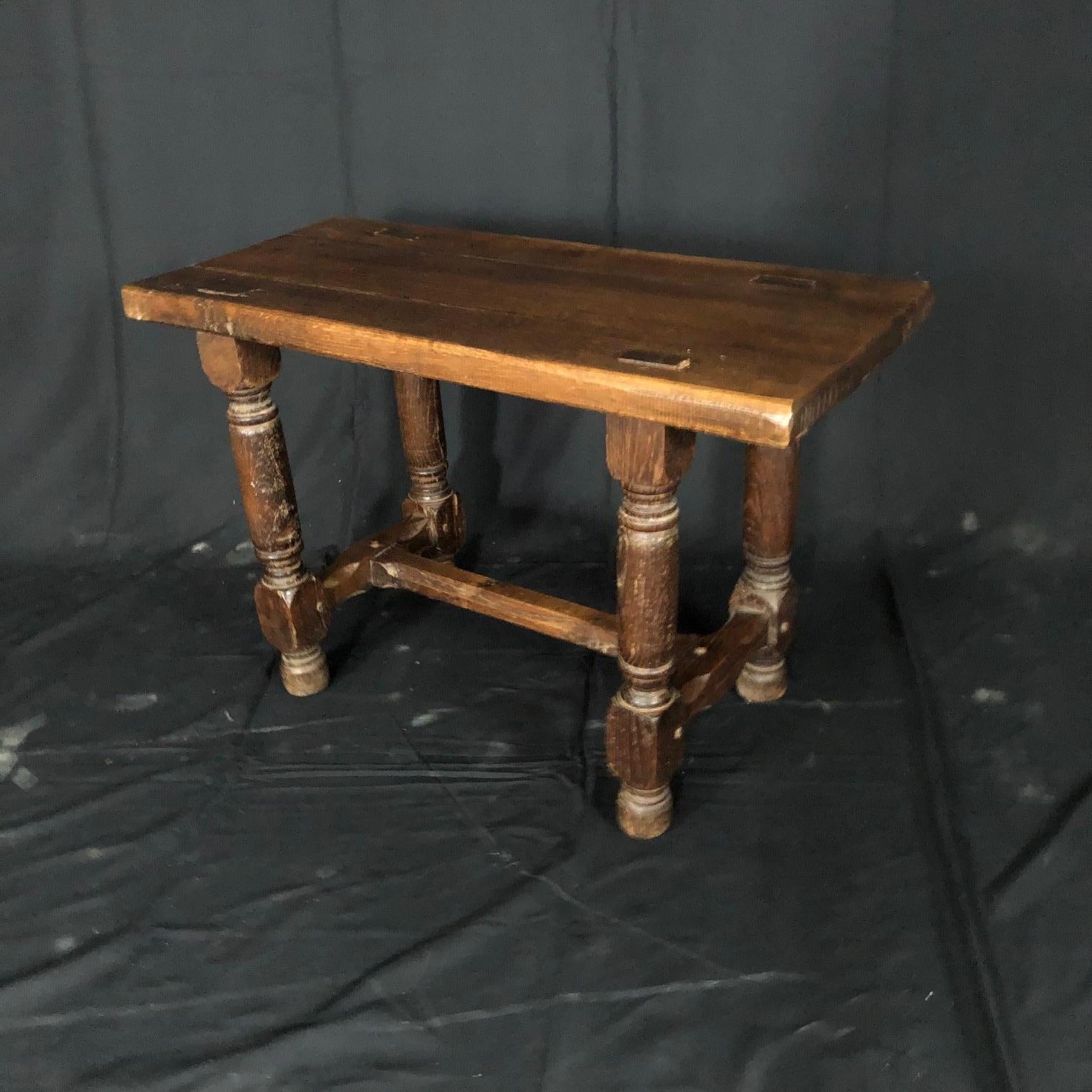 Rustic and charming French provincial 19th century oak farm bench with early pegged construction and turned legs.