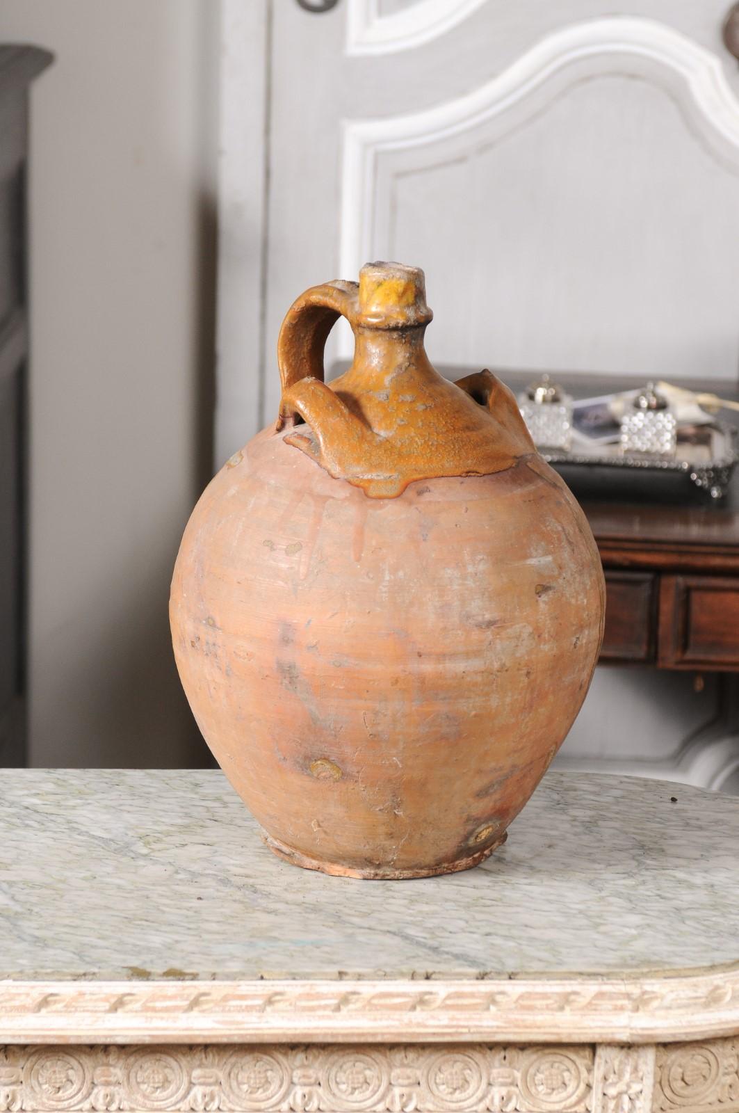 Unglazed Rustic French 19th Century Pottery Jug with Yellow Glaze and Three Handles For Sale