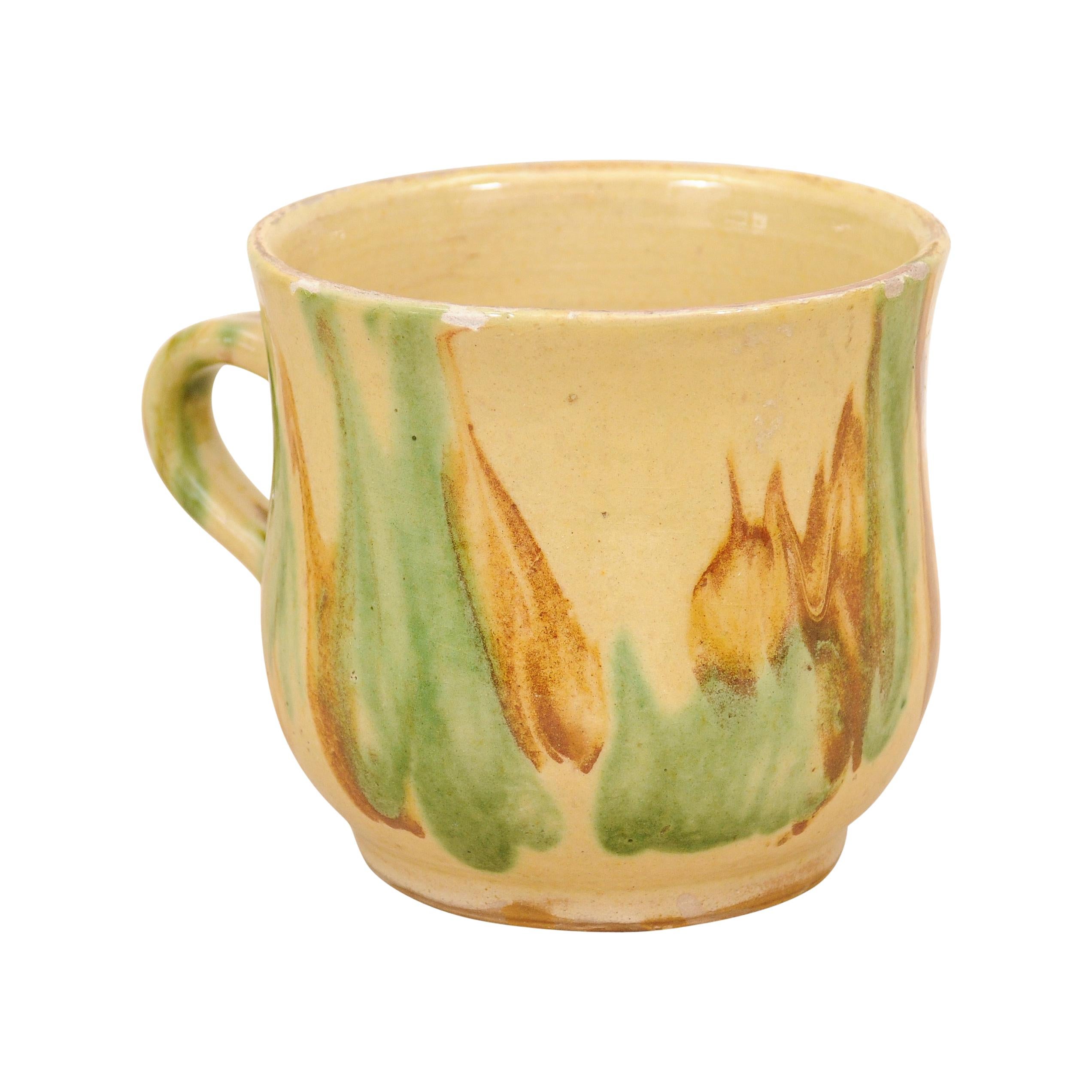 Rustic French 19th Century Pottery Mug with Yellow, Green and Rust Glaze For Sale
