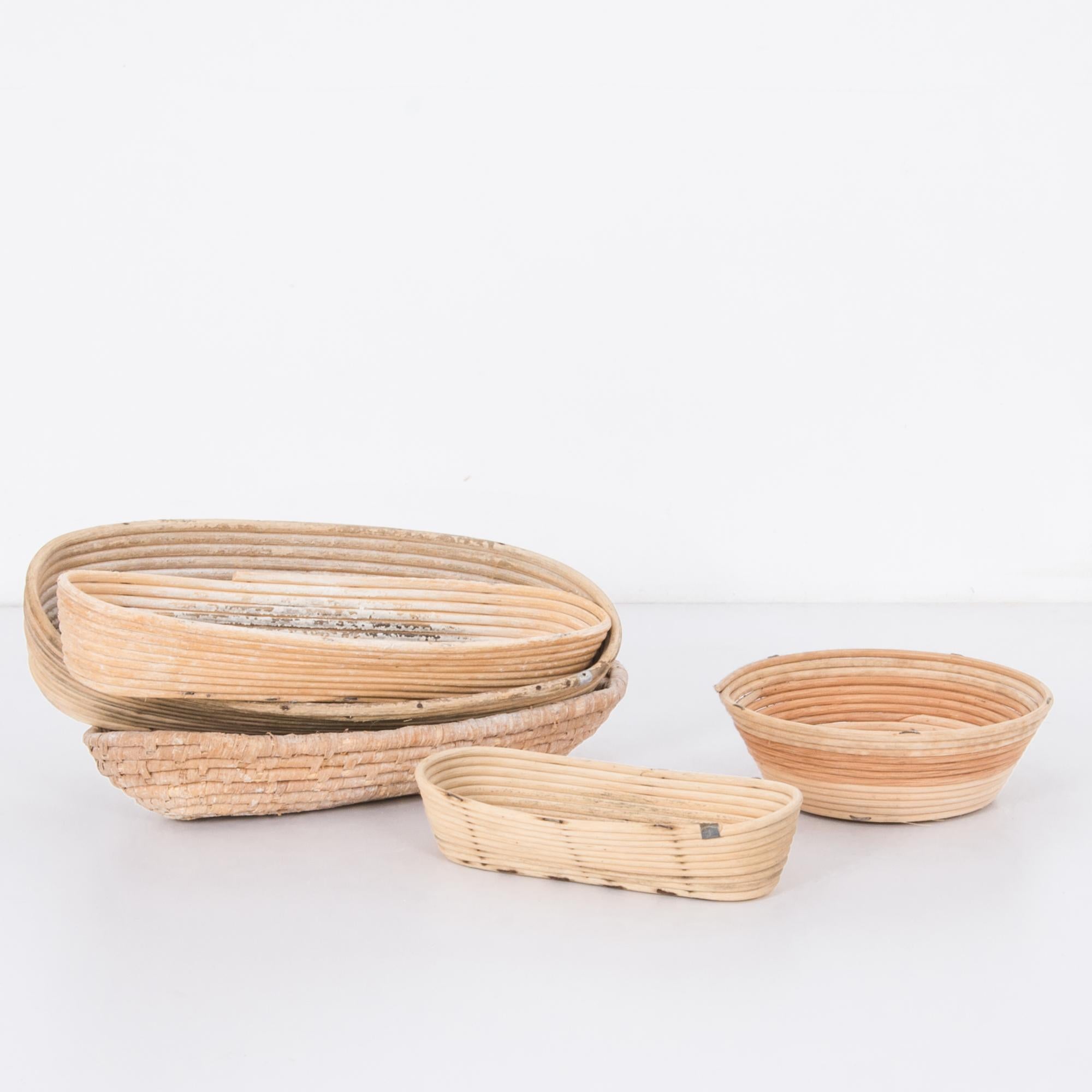 A set of five bread-proofing bannetons from rural France, circa 1900. These antique bread forms are made from coiled cane in a variety of shapes, sizes and styles, for the purpose of proofing various French provincial loaves. The gentle weathering