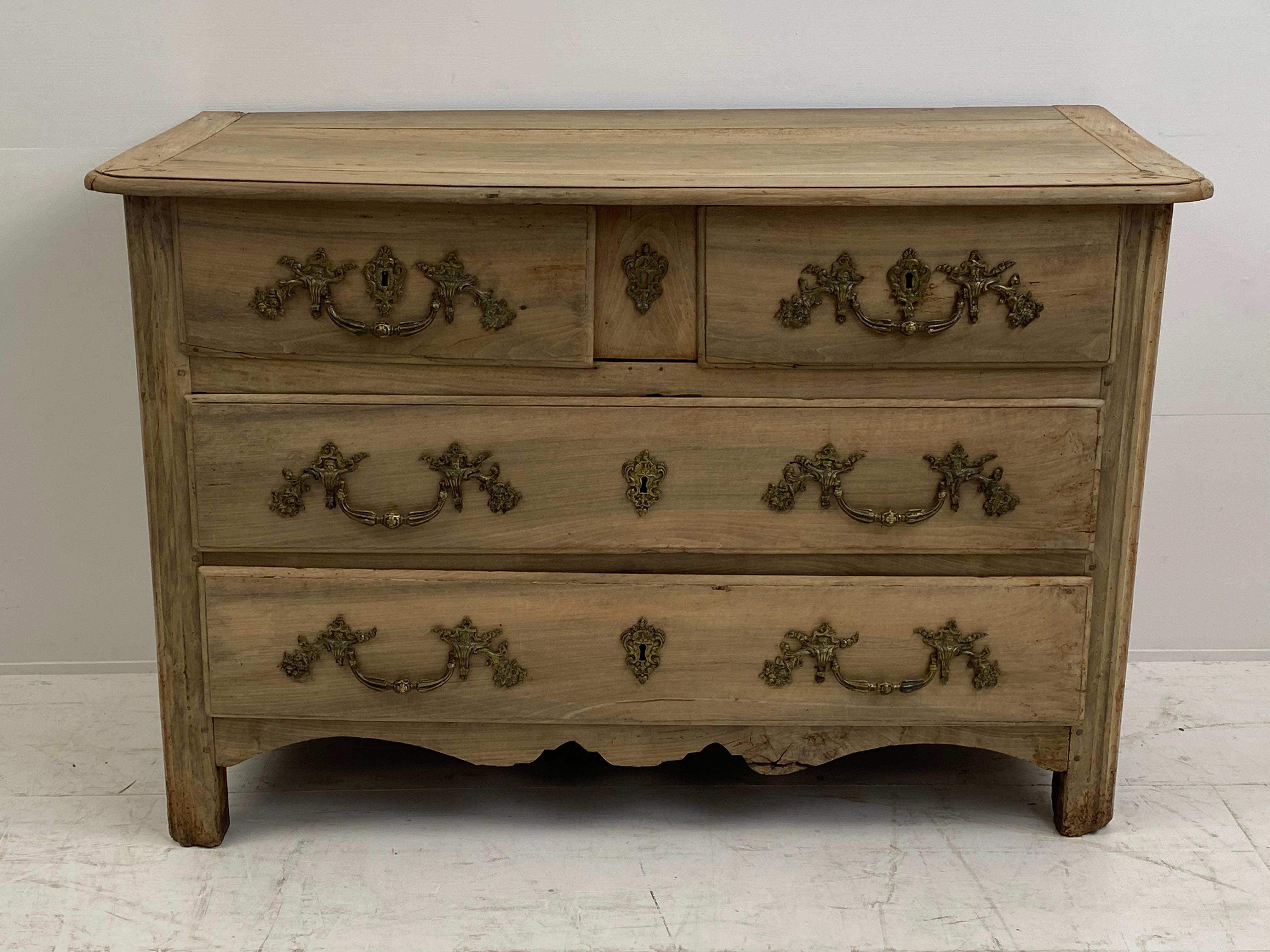 Elegant French Commode in a bleached Walnut,
from the Paris Region,18 th Century,
original Bronze Handles,
3 big drawers and 2 small drawers,
excellent antique patina and warm wear of the wood,
very elegant and decorative classical commode.