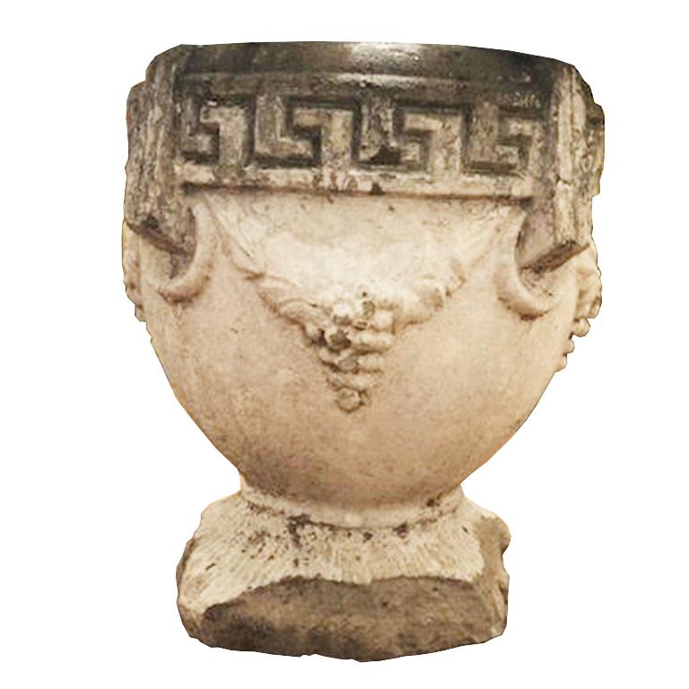 Concrete urn garden planter. Featuring Greek key around the top of the planter. And grapes surrounding with figural round handles. Approximately 100 lbs each. Some minor losses around the base, but still very sturdy.