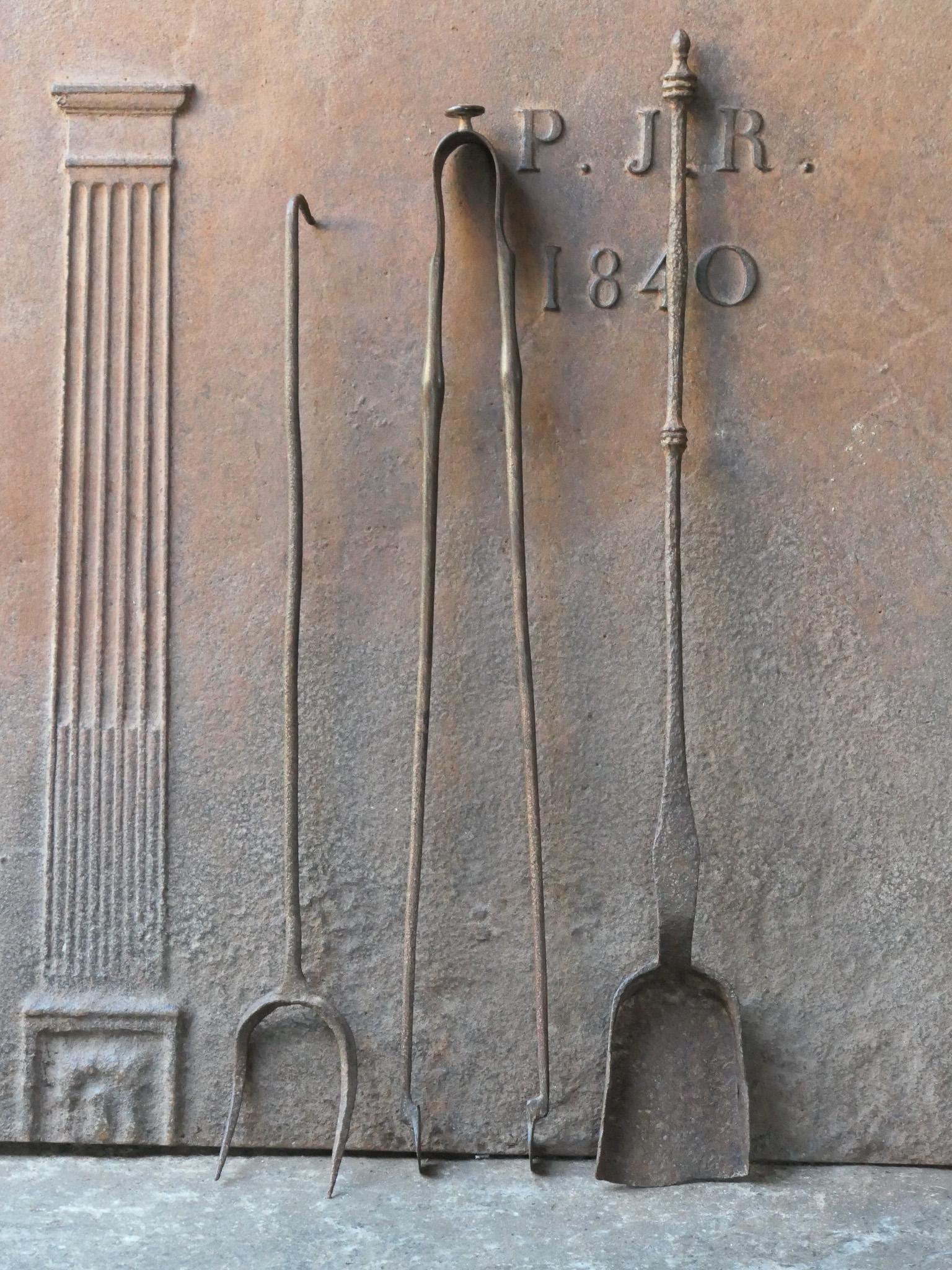 Rustic 17th-18th century French fireplace tool set. The tool set consists of fireplace tongs, shovel and a fire fork. The tools are made of wrought iron. The set is in a good condition and fit for use in the fireplace.