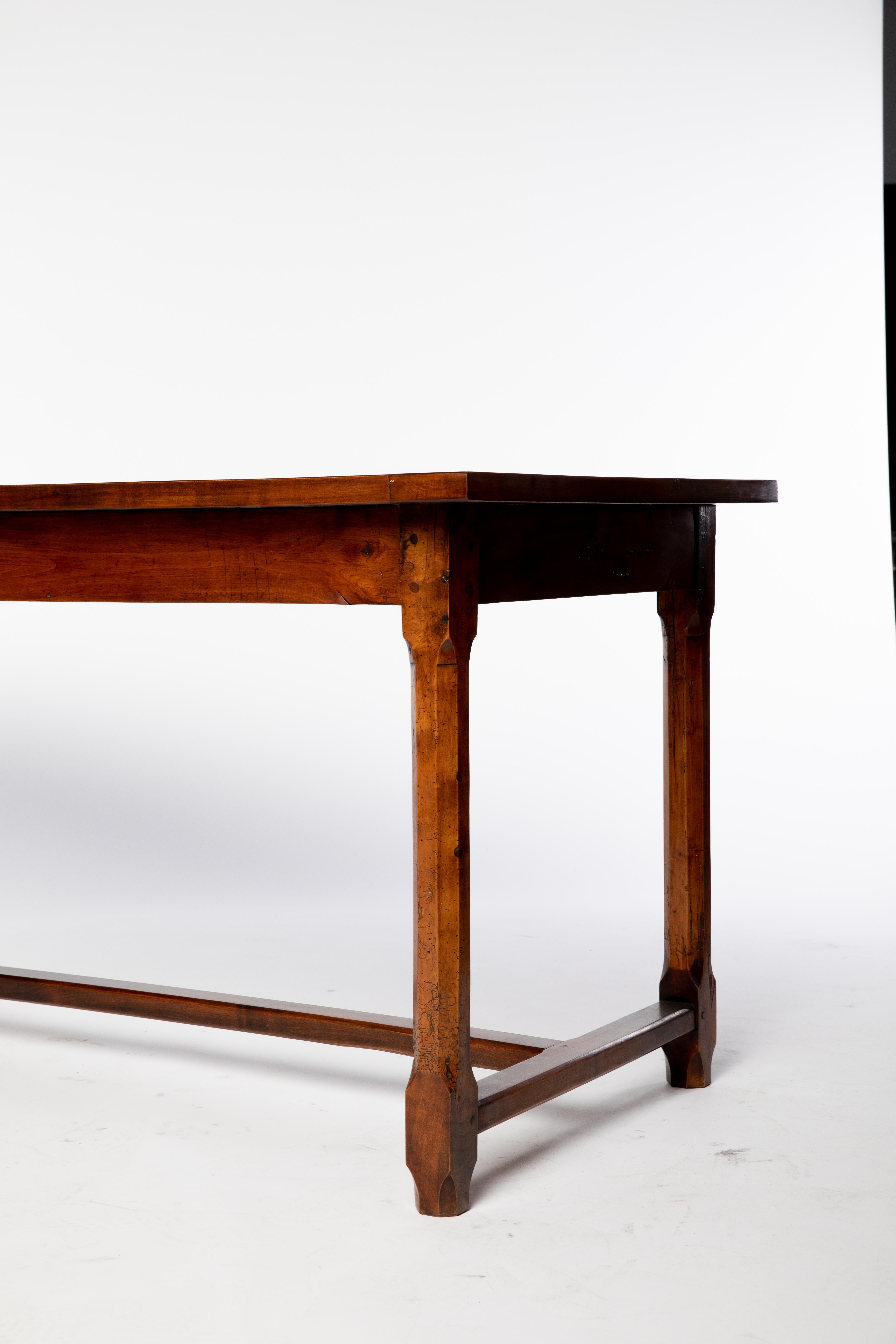 Rustic French fruitwood farmhouse table, mid 19th c., having rectangular plank top, over stretcher-joined octagonal legs, patched repairs to tabletop.