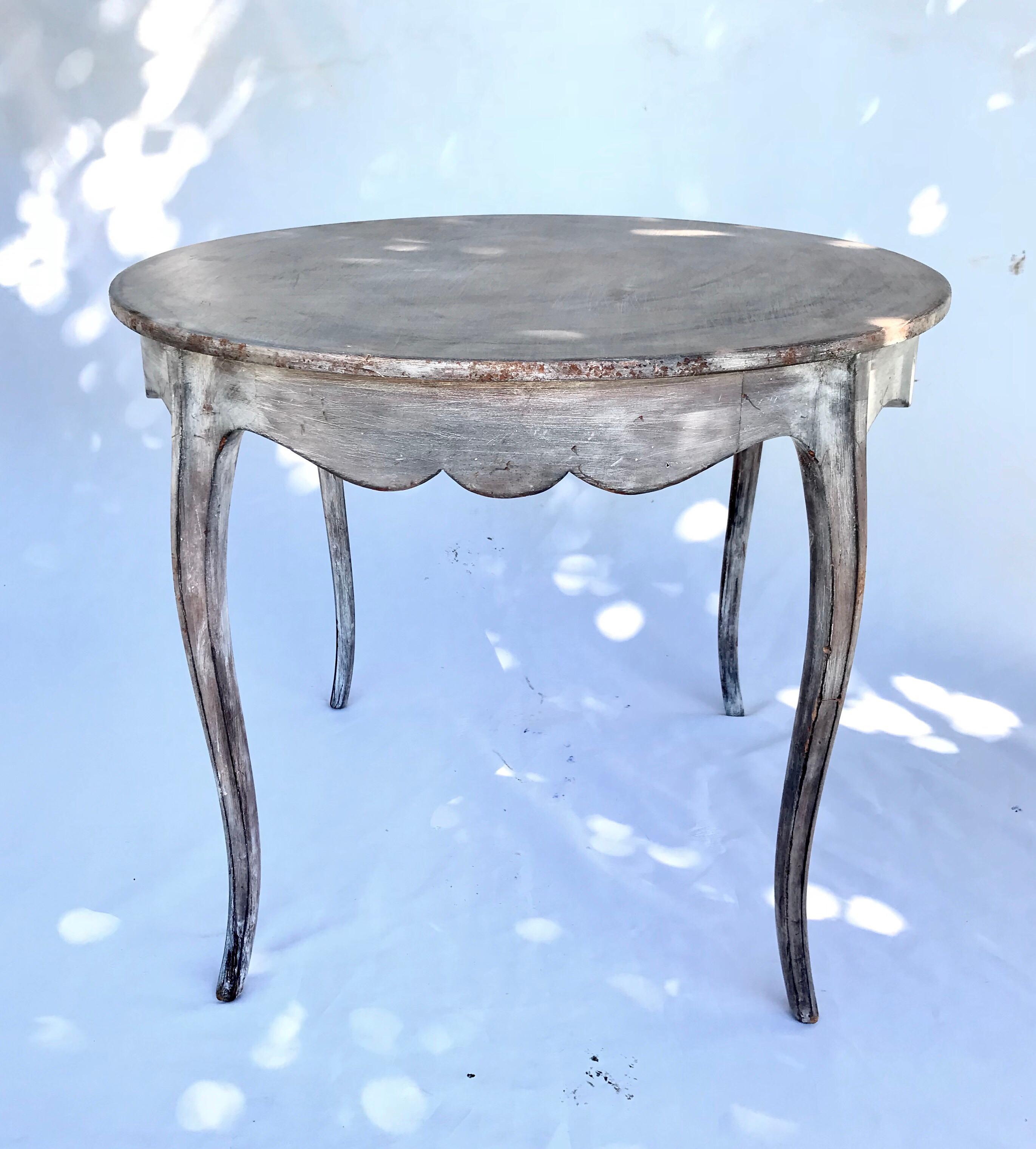 An attractive Louis XV style side table having a bleached, pickled and burnished finish in the Provincial Gustavian taste. The round topped table is supported by nicely performed cabriole legs. A Classic.