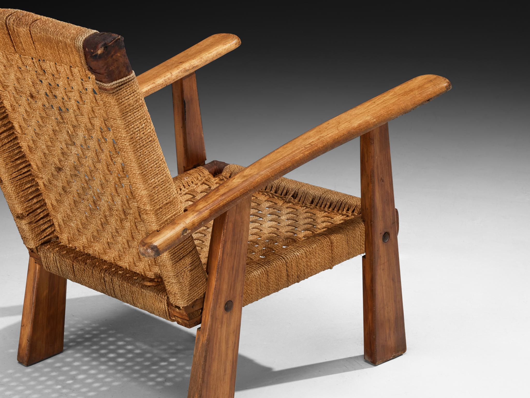Lounge chair, rush, beech, France, 1940s

Rustic-inspired French armchair from the 1940s. The structure is composed of rectilinear wooden components, slightly tapered and angled to produce a wide, grounded stance. The rear legs extend upward into