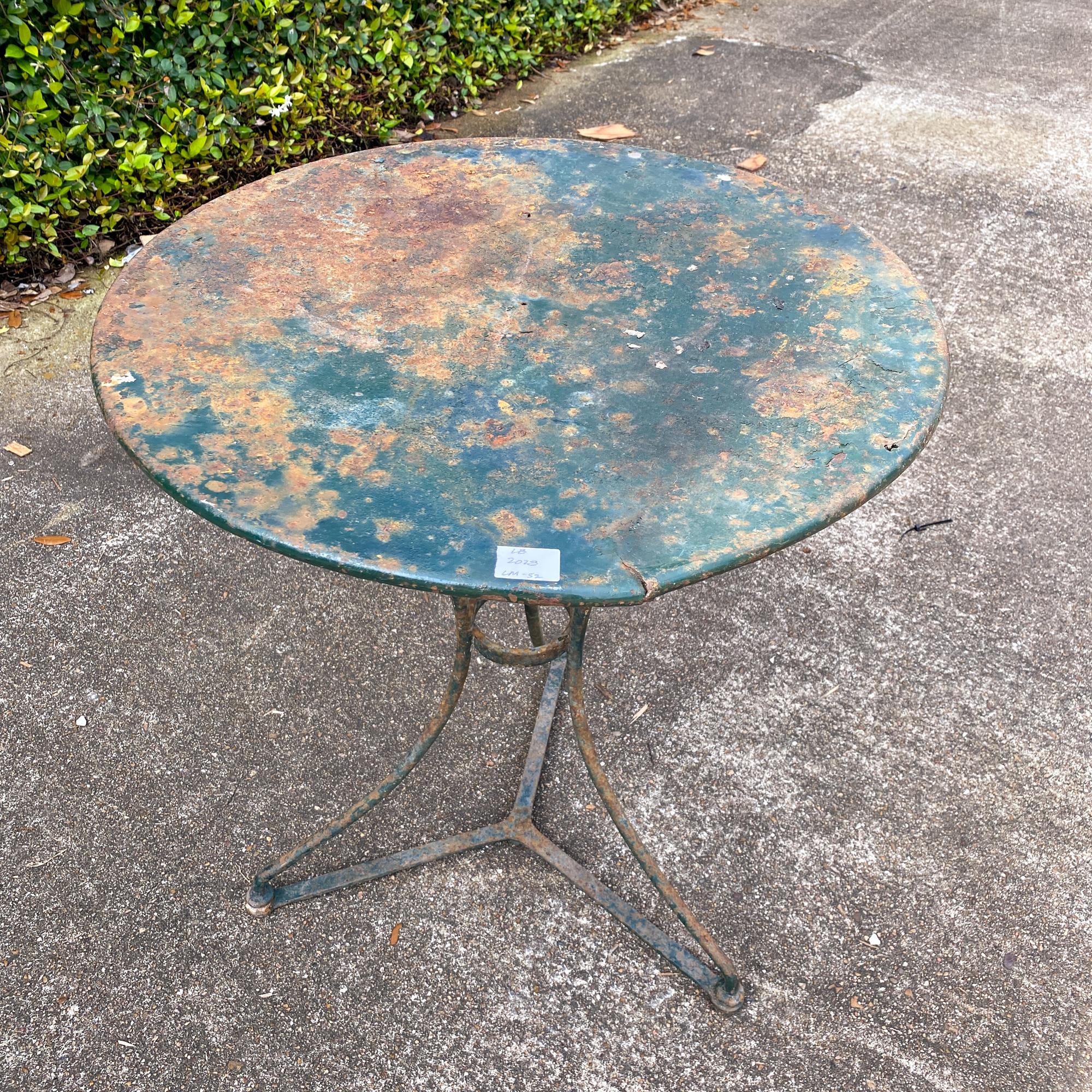 This is a charming and rustic metal bistro table that has been painted in a deep, forest green finish. Three legs with the Classic ring detail at center. Perfect as a perch for plants, a small table for outdoors or as a rustic accent indoors. There