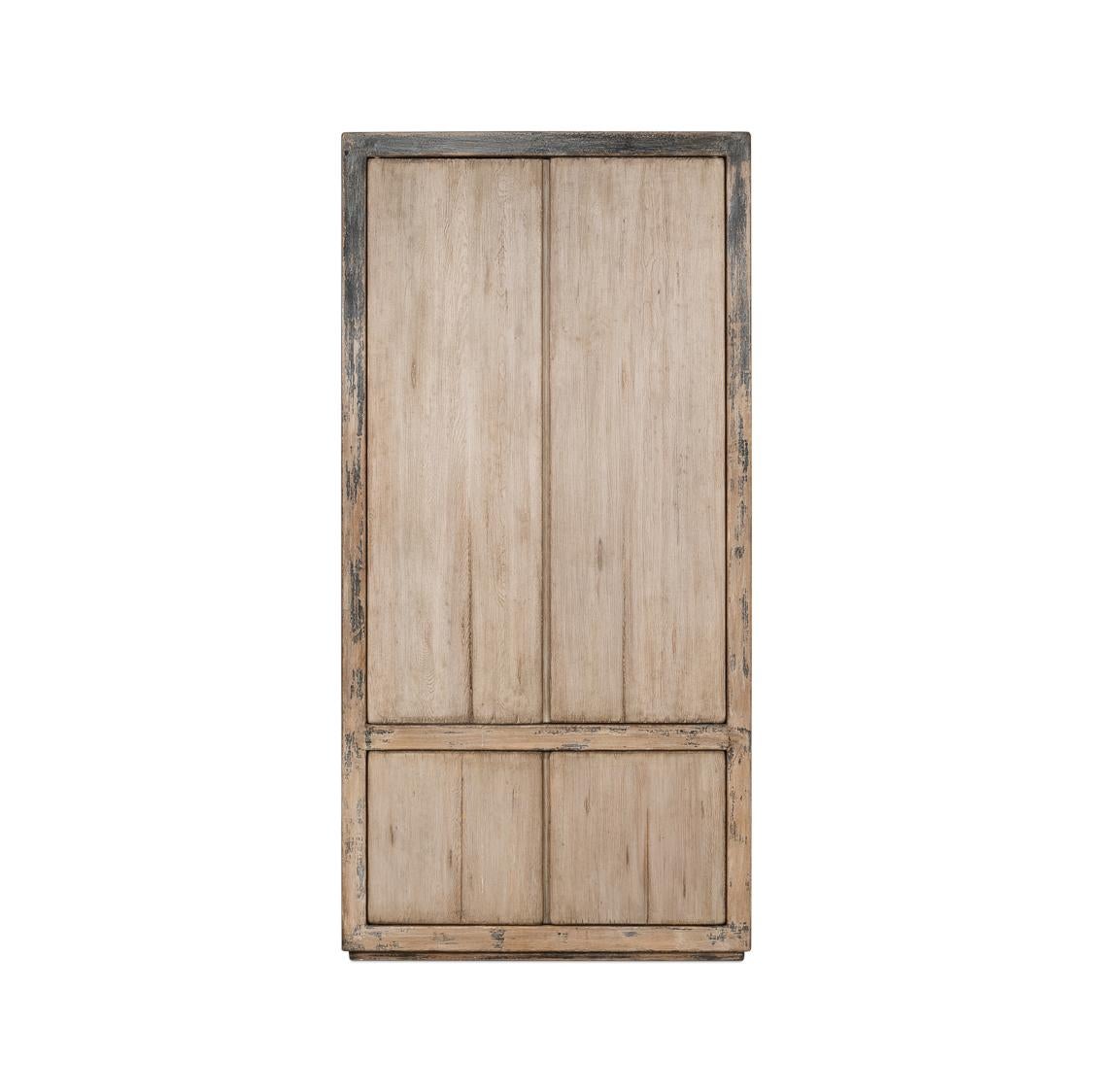 Made from reclaimed pine and finished in an antiqued and distressed French grey.

Standing proudly, it offers an imposing presence while promising an abundance of storage. With four cupboard doors that open to reveal removable shelves – the cabinet