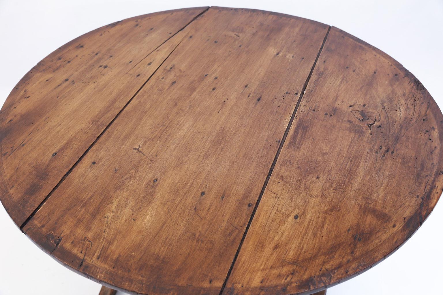 Rustic French vendange table (wine tasting table) in pine and oak. Simple, elegant design with functional tilt-top. The top originally covered and decorated with the name and logo for the vineyard in which it was used. Today this table can serve as