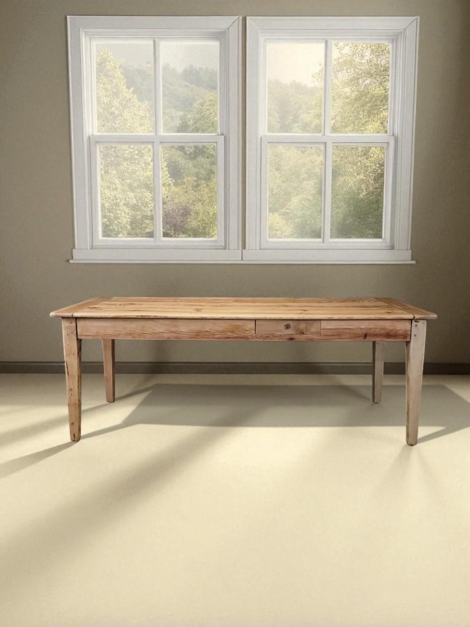 This long, narrow table reflects the honest functionality of early 20th-century French provincial work furniture. Made from solid pine, it features a raw, stripped finish that reveals the wood’s natural grain, knots, and imperfections, emphasizing