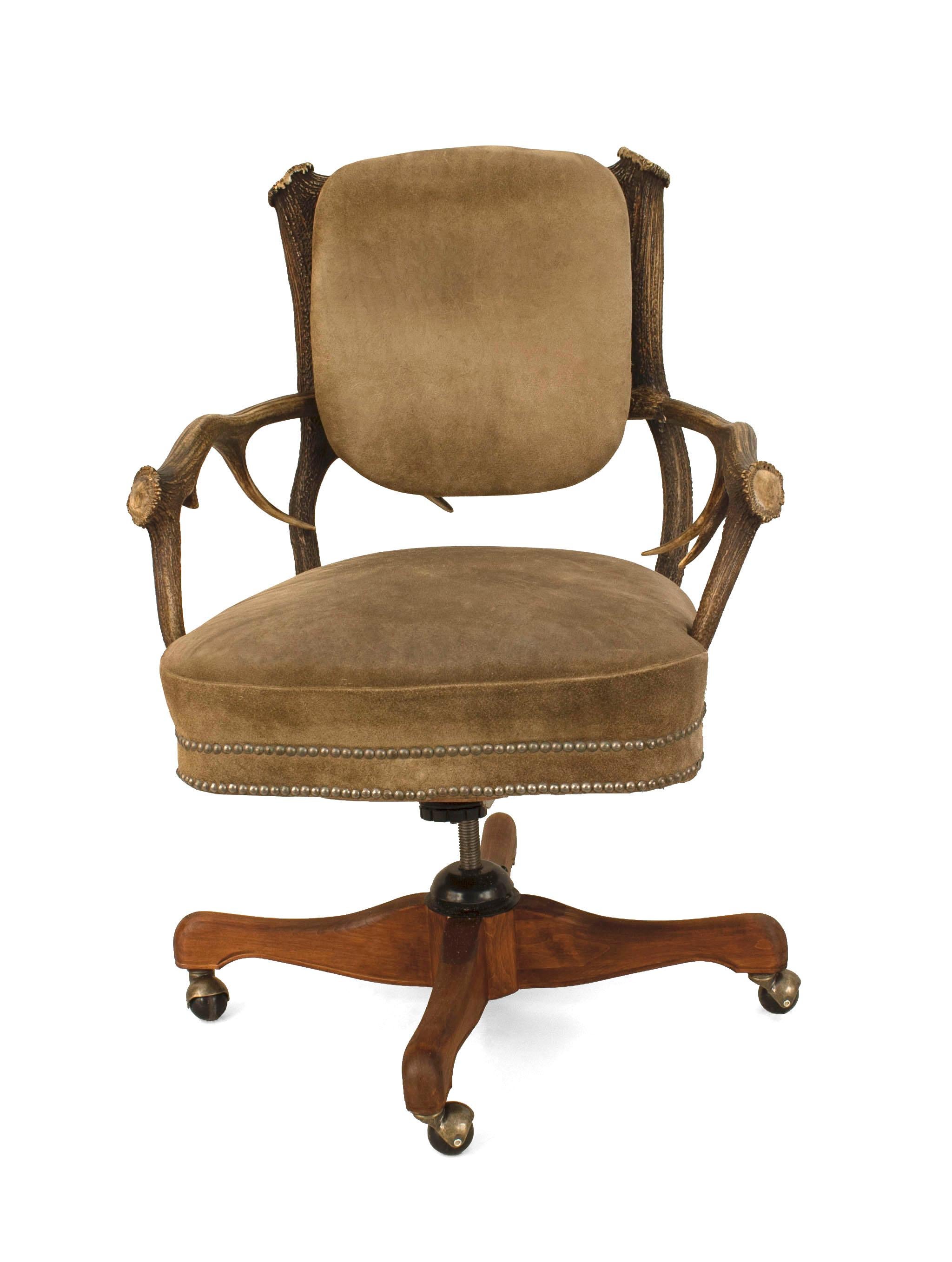Rustic German horn and antler design (late 19th Century) swivel base arm chair with taupe suede upholstered seat and back.
