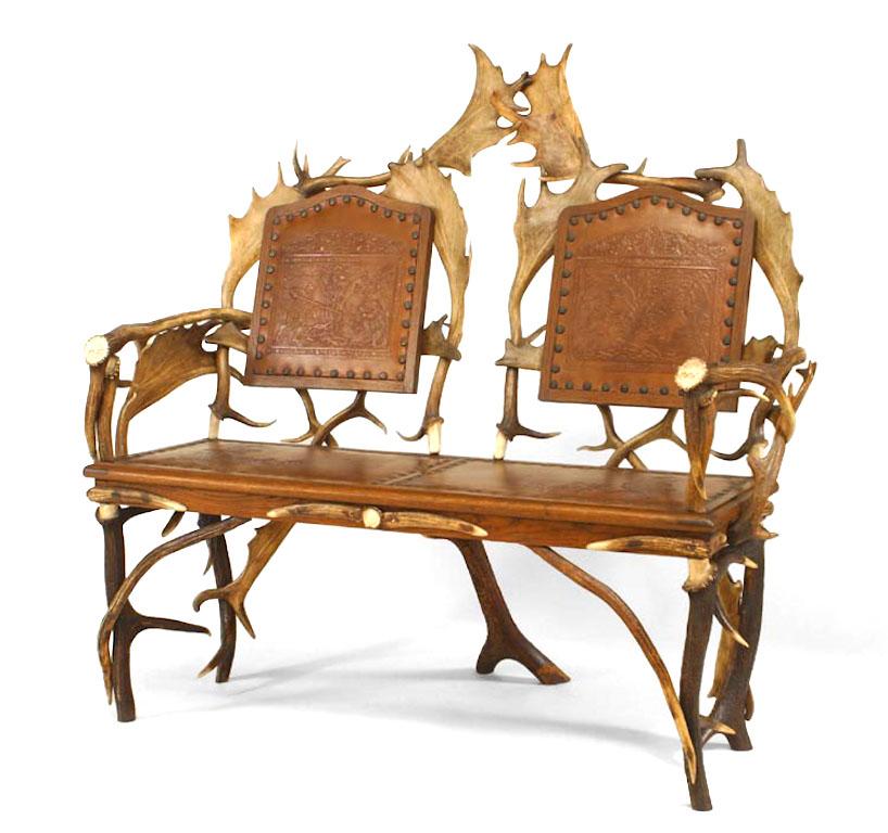 Rustic German (19th century) oak and antler loveseat with carved medallions on arms and brown embossed leather seat & back with nailhead detail (See also: Living room set: 059336A, matching chairs: 059337).