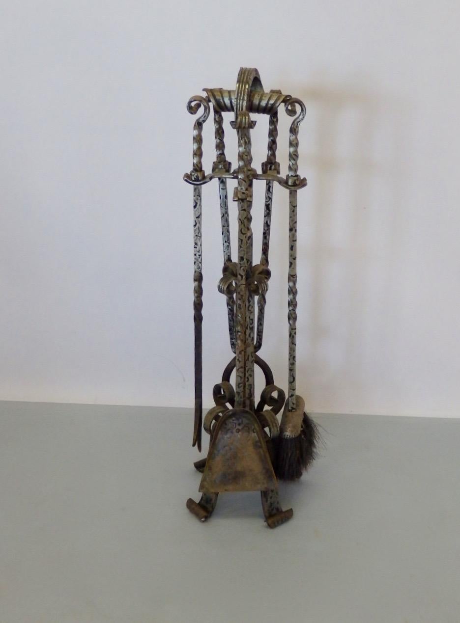 Heavily wrought iron fire place tools on wrought stand. Each tool measures 27.5 long.