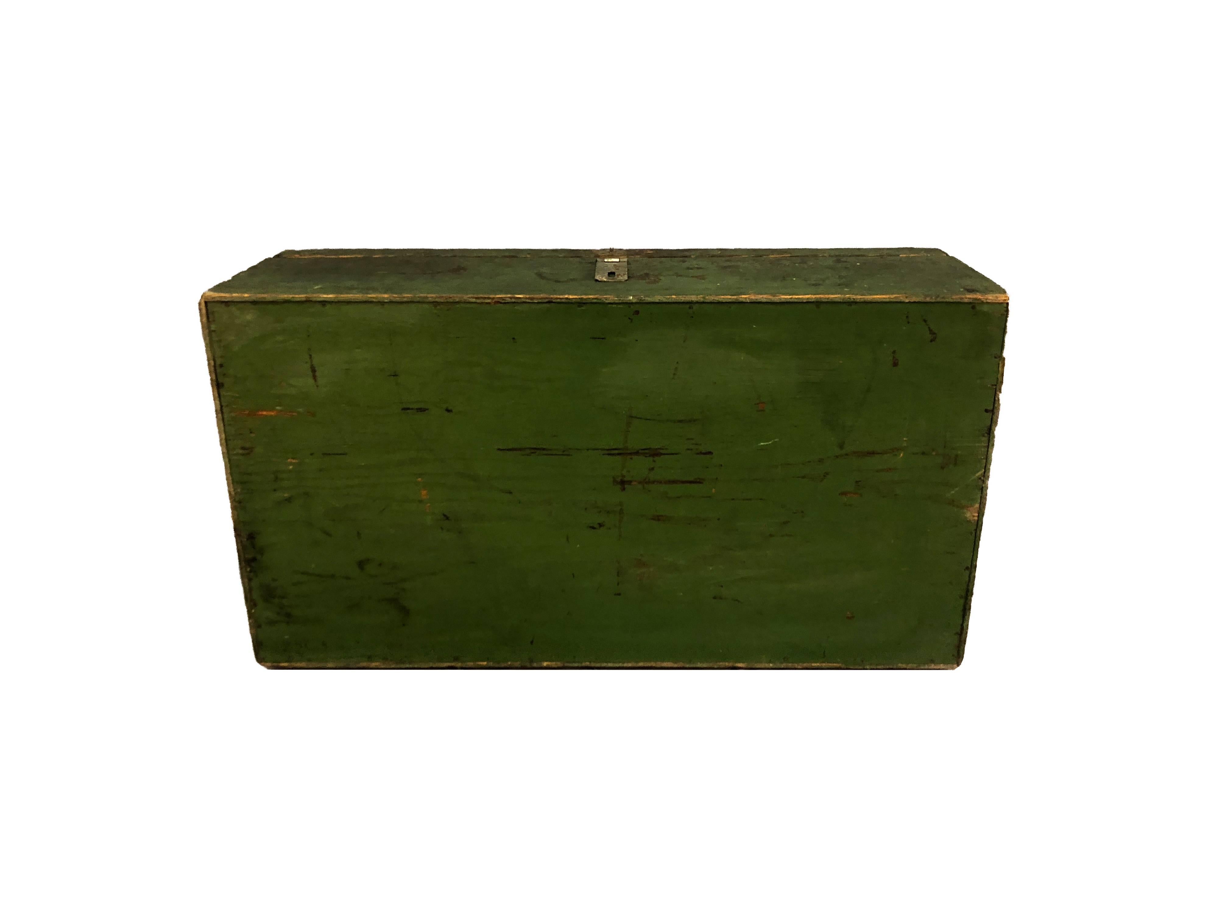 Rustic handmade rectangular green painted tool chest. The inside of the chest has drawers for storage and the exterior has iron handles. Unmarked.