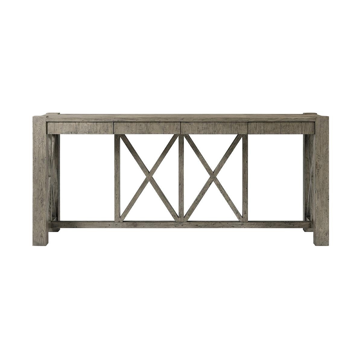 Featuring a planked oak top finished in a greyed echo oak, this console table is lightly distressed to enhance its warm, inviting look. It provides a generous surface area that is perfect for displaying decorative items, books, or even serving
