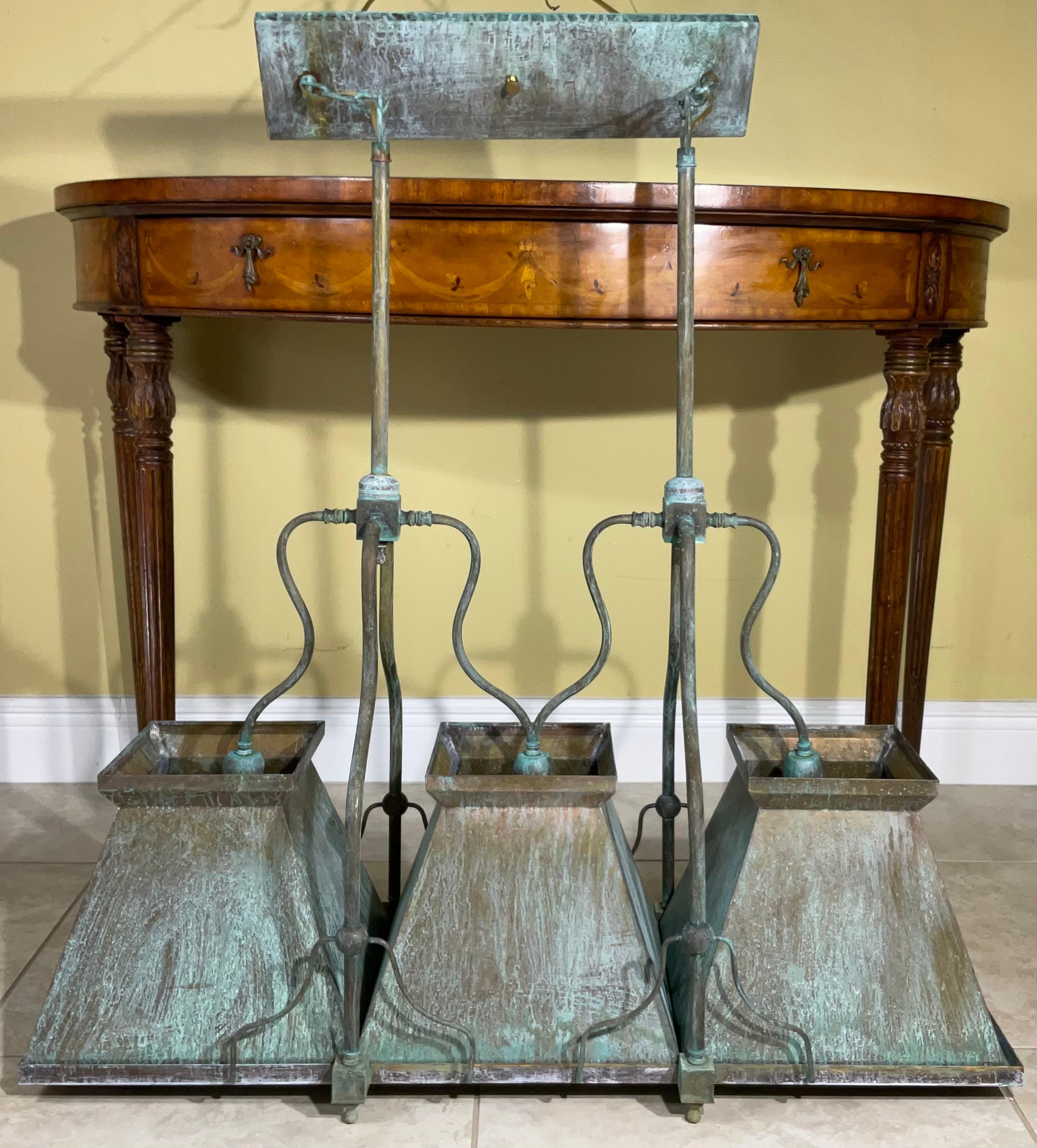 Hand crafted light fixture made of solid brass with three made shades, great greenish rustic patina Looks great over a kitchen island, dining table or in a billiard room. wired and ready to use each shade has one 60/watt light . Original canopy