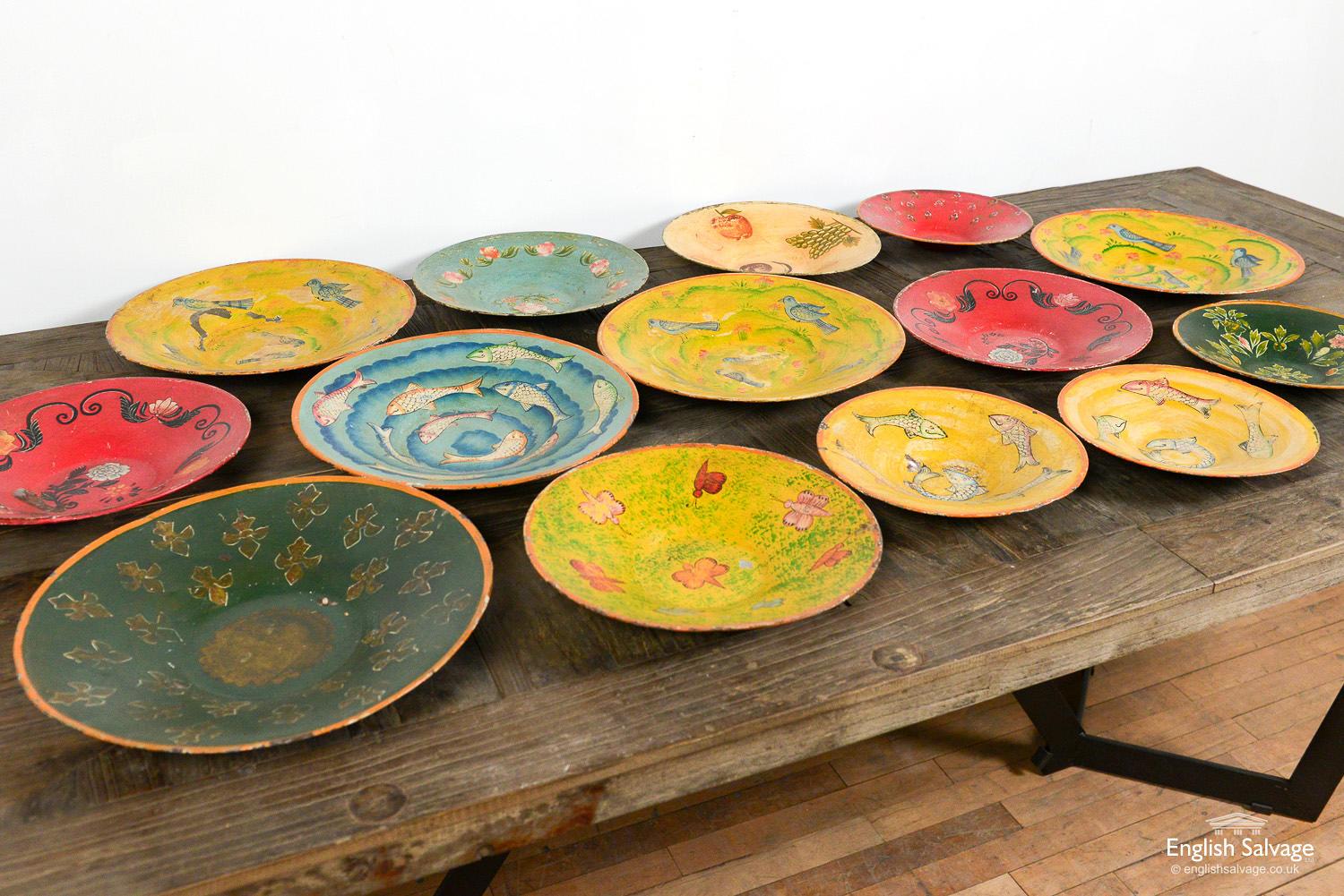 Delightful vintage hand painted metal plates / platters / bowls / dishes in three different sizes. There are different hand painted floral, fish, bird and fruit designs. Each is unique and has weathered differently with chips and scratches forming a