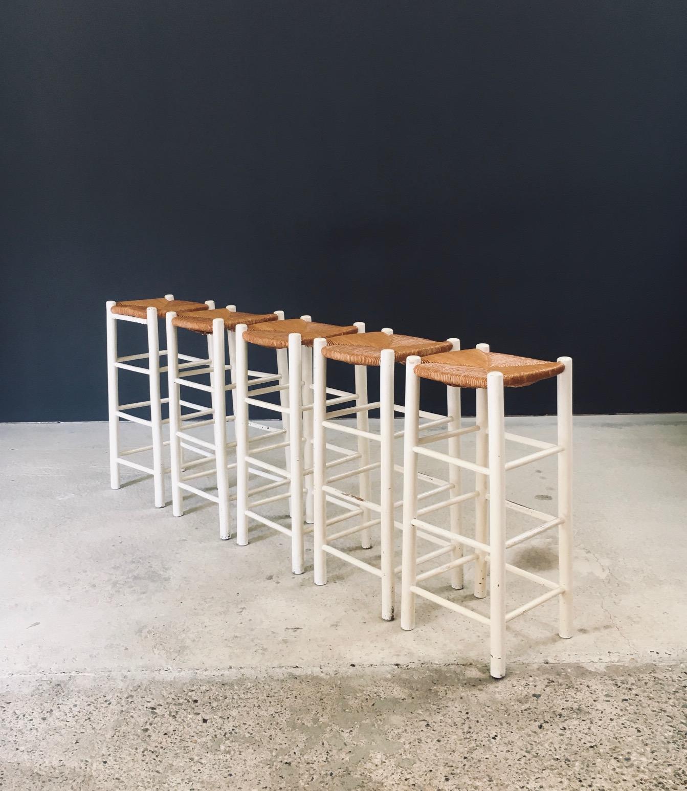 Vintage Rustic Handcrafted High Bar Stool Set of 5. Made in France, 1940's / 50's period. In the manner of Charlotte Perriand stools. White lacquered oak frame with french rush woven seats and three spurts on each side. These come in good and sturdy