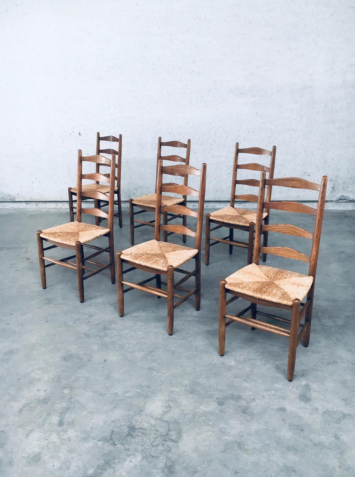 Vintage Rustic Handcrafted Oak & Rush Ladder Back Dining Chair set of 6. Made in Belgium, late 1940's, early 1950's. Solid oak constructed chair with woven rush seat. Ladder back model with several spindles in the bottom base for strenght. All