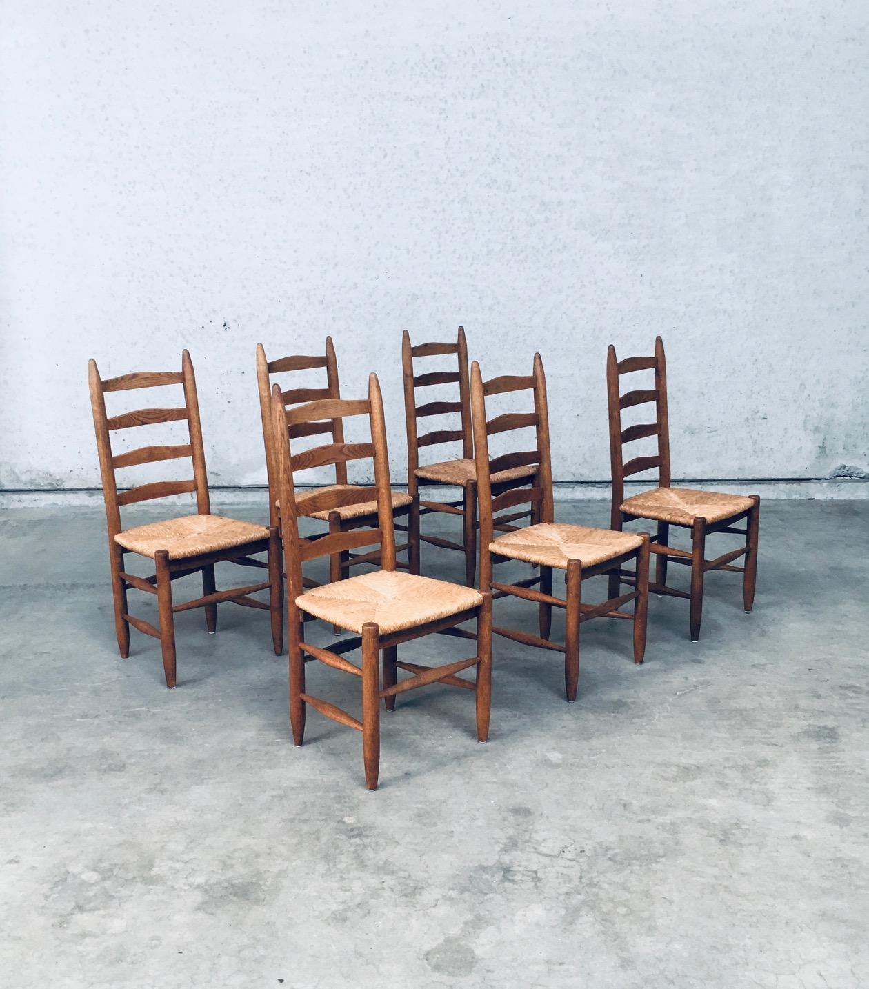 Vintage Rustic Handcrafted Oak & Rush Ladder Back Dining Chair set of 6. Made in Belgium, late 1940's, early 1950's. Solid oak constructed chair with woven rush seat. Ladder back model with several spindles in the bottom base for strenght. All