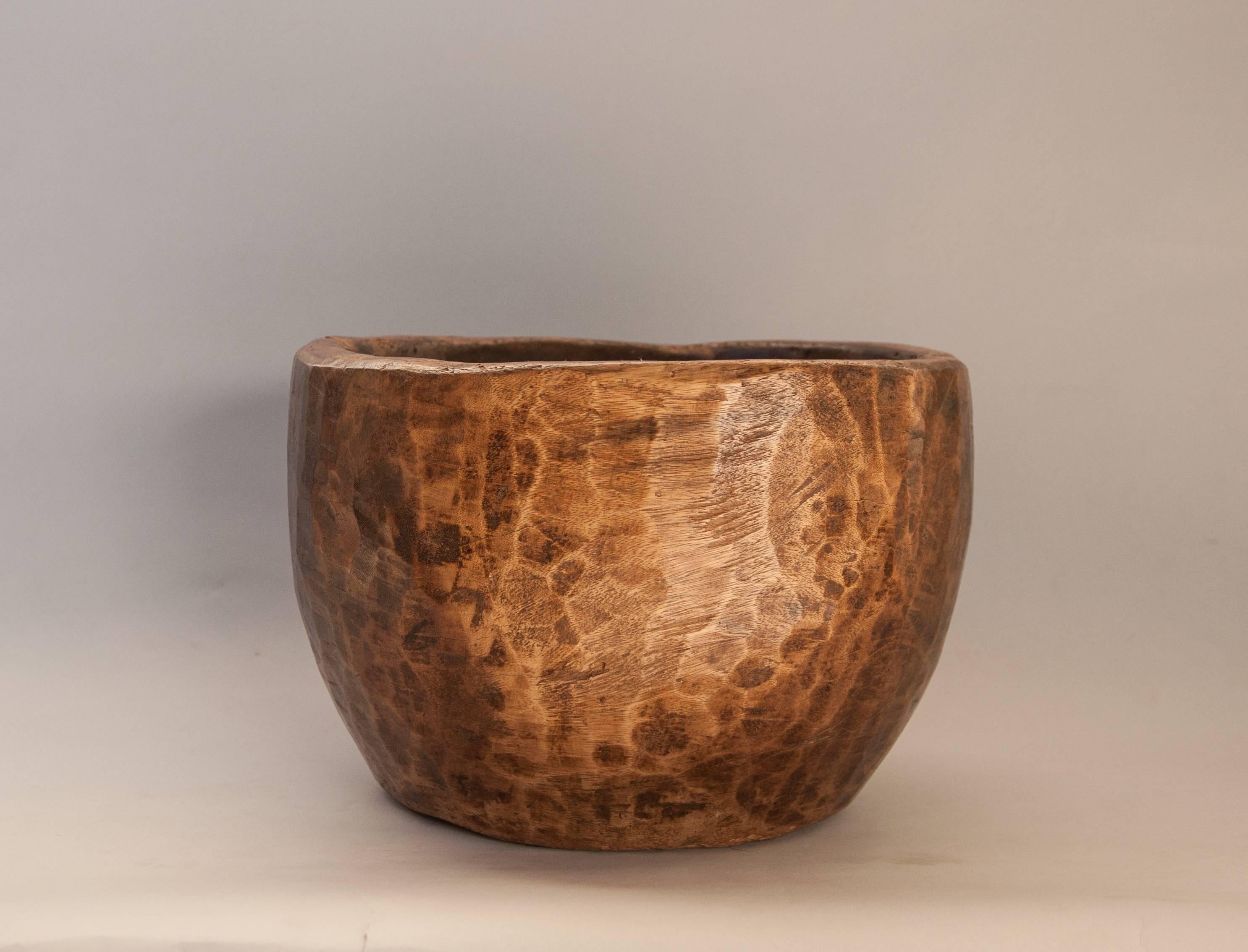 Rustic hand hewn wooden mortar bowl, teak. Java, mid-20th century.
Offered by Bruce Hughes.
This rustic wooden teak bowl was fashioned by hand using very basic tools and was used as a mortar in a rural household.
The interior of the bowl has a