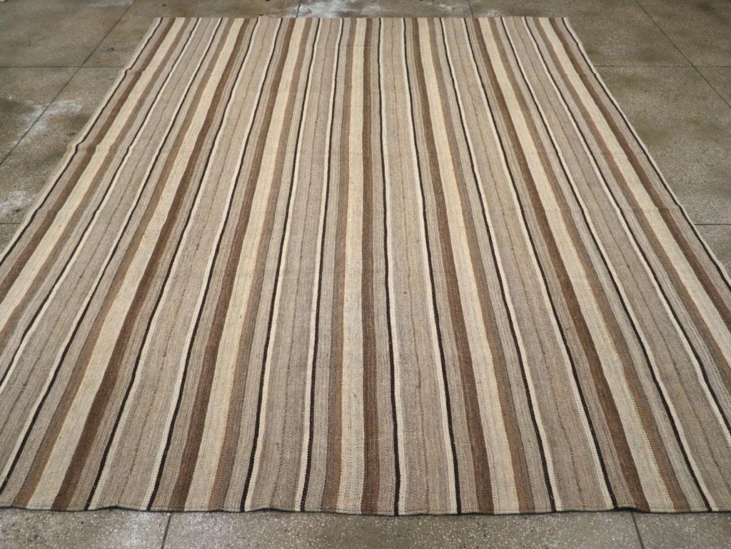 A new rustic Turkish flatweave Kilim room size carpet handmade during the 21st century.

Measures: 10' 9