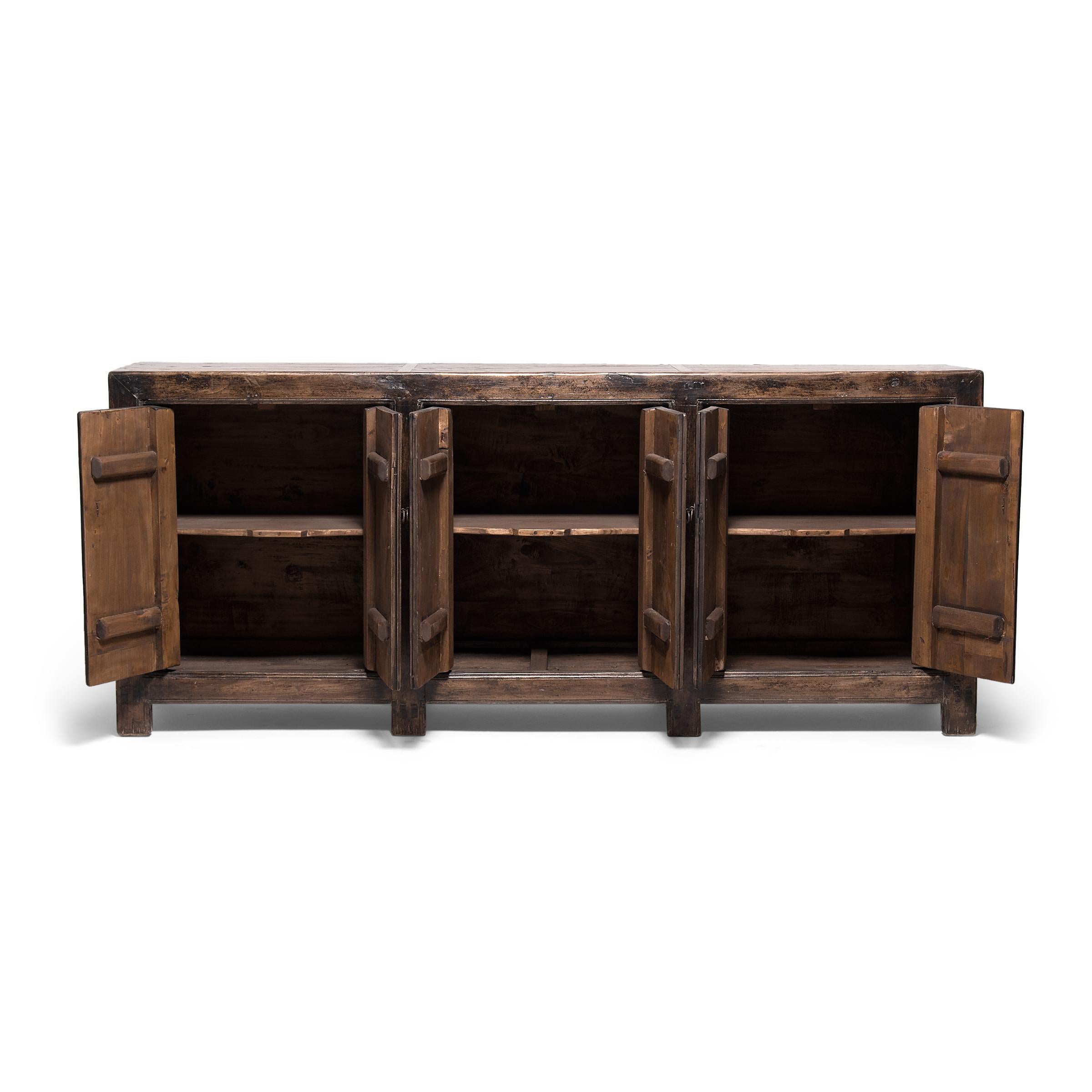 Created in the style of Mongolian storage coffers, this early 20th century herdsman's chest has a straightforward design and plenty of rustic appeal. Originally configured to open from the top, this chest was modified with front-facing doors by our