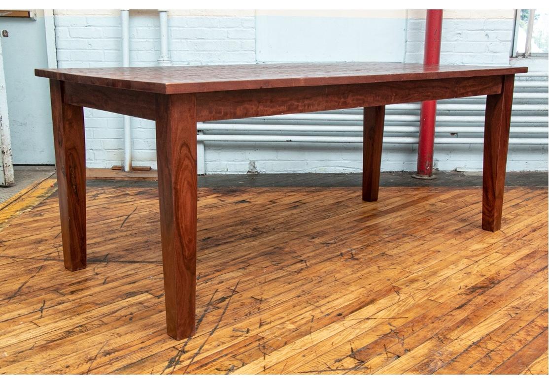 Quite elemental in form, this Rustic table features attractive deep grained wood with a tactile hewn top finish. The wood is very heavy and tight grained and reminiscent of a South American exotic hardwood. The table is raised on thick square