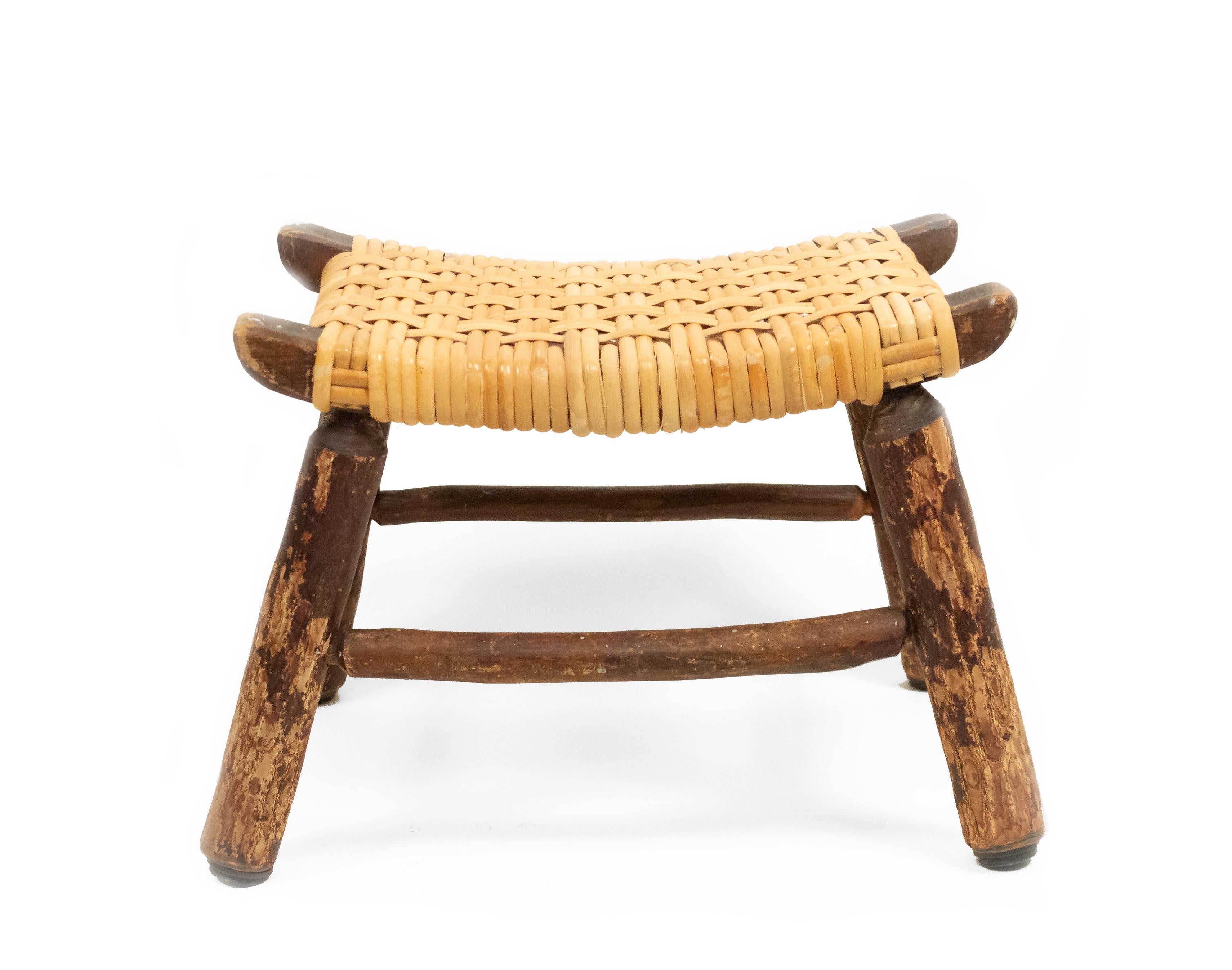 Rustic Old Hickory style footstool with woven cane seat.
  