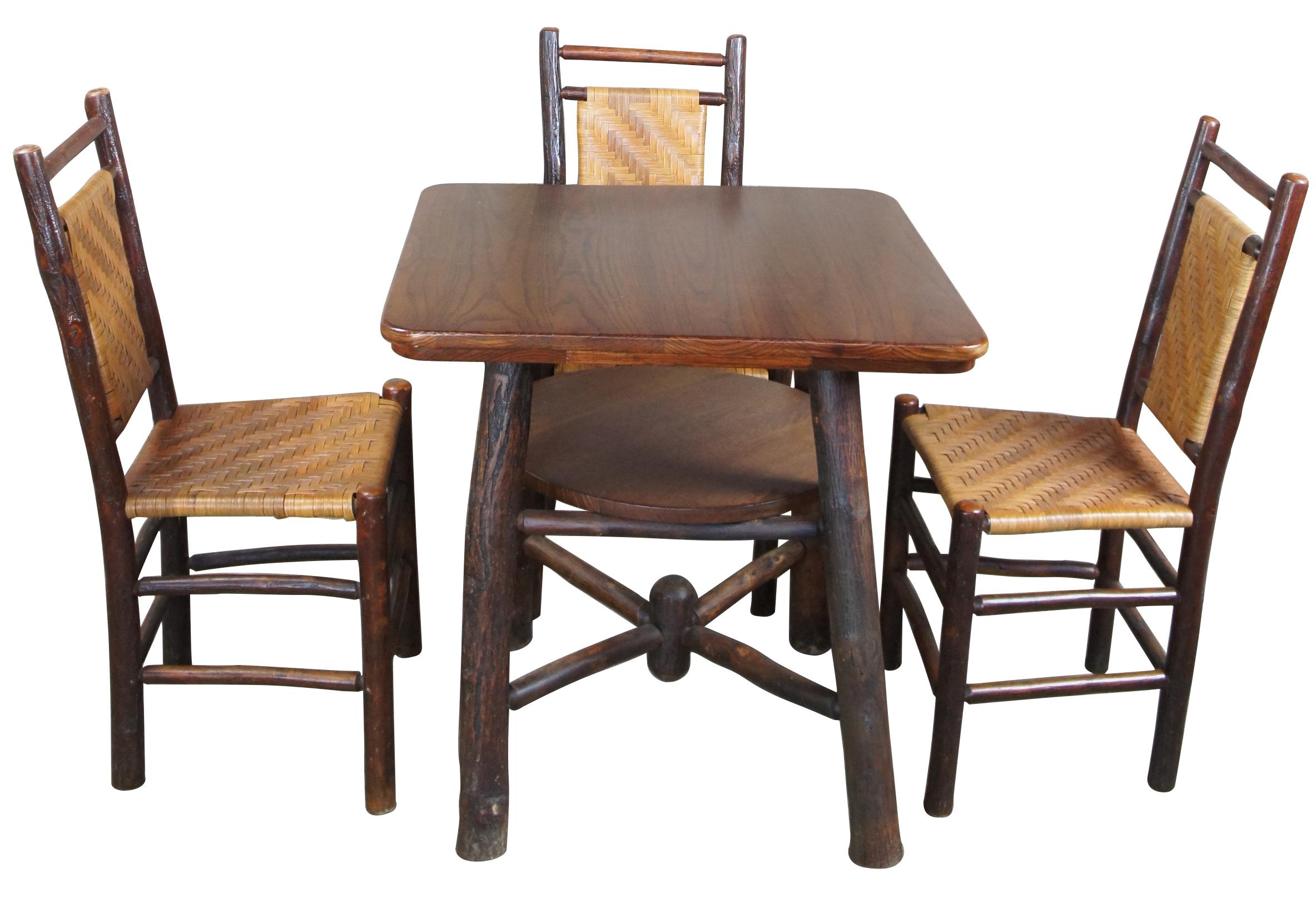 Rustic Hickory Furniture Company game table & chairs no 103 & 19 Adirondack lodge

Pre-1930s parlor game or dining set by The Rustic Hickory Furniture Company. Features a primitive log and rattan style. Item no. 103 & no. 19 in original catalog.