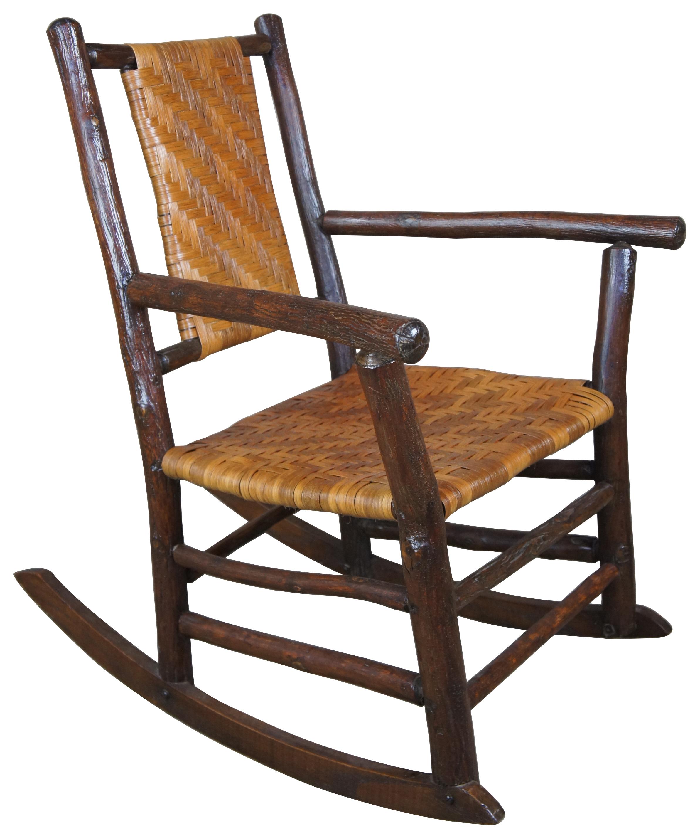 Rustic Hickory Furniture Company rocking armchair no. 21 Rocker Adirondak Lodge

Pre 1930s rocking chair by The Rustic Hickory Furniture Company. Features a primitive log and rattan style with flared arms and a nice wide seat. The Rustic Hickory
