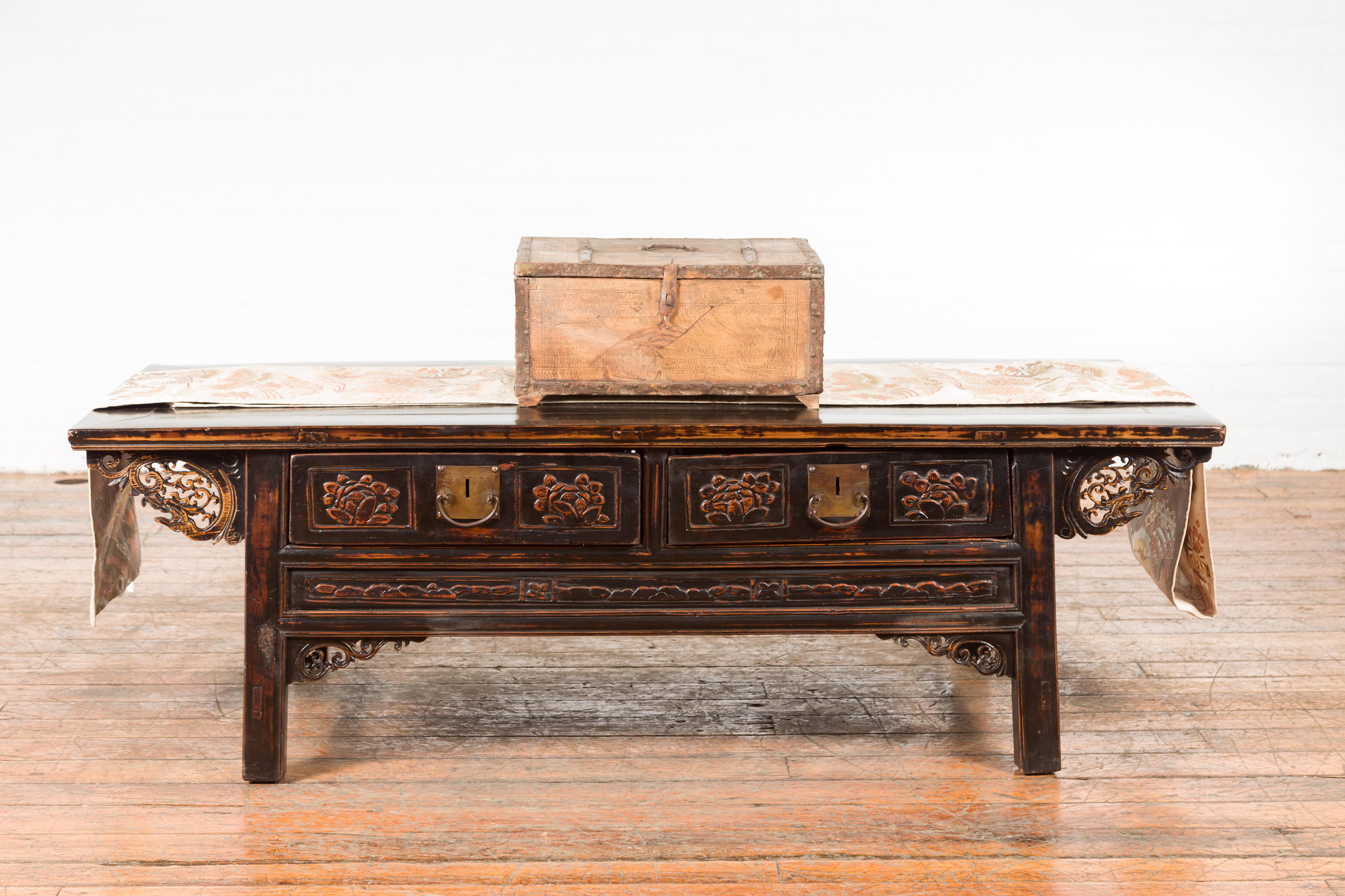 An Indian rustic wooden box from the 19th century, with nicely weathered appearance, iron details and incised motifs. Created in India during the 19th century, this wooden box features a rectangular lid half opening to reveal a small interior.